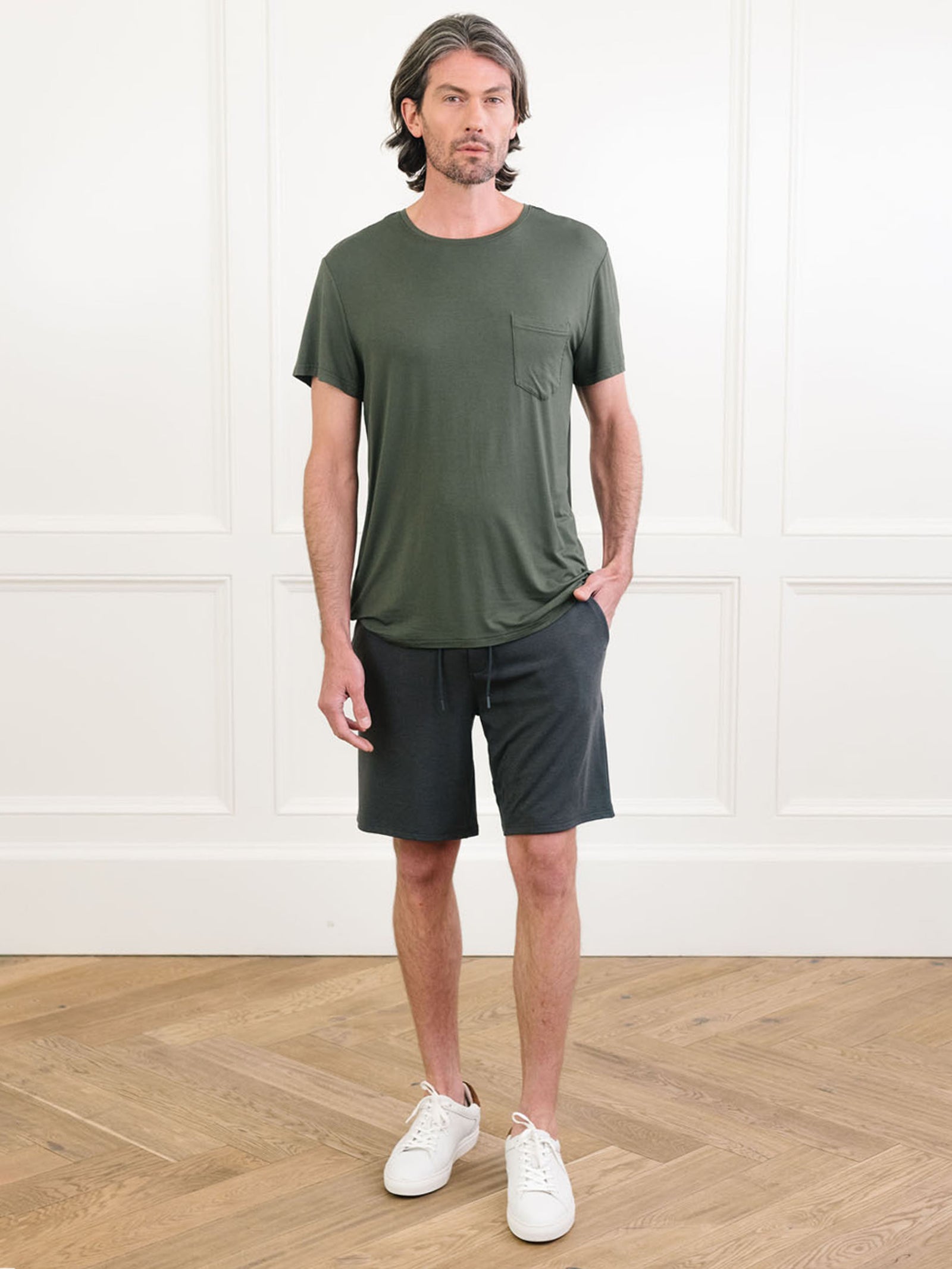 Olive Men's Stretch-Knit Bamboo Lounge Tee. A man is wearing the lounge tee in a well lit home.