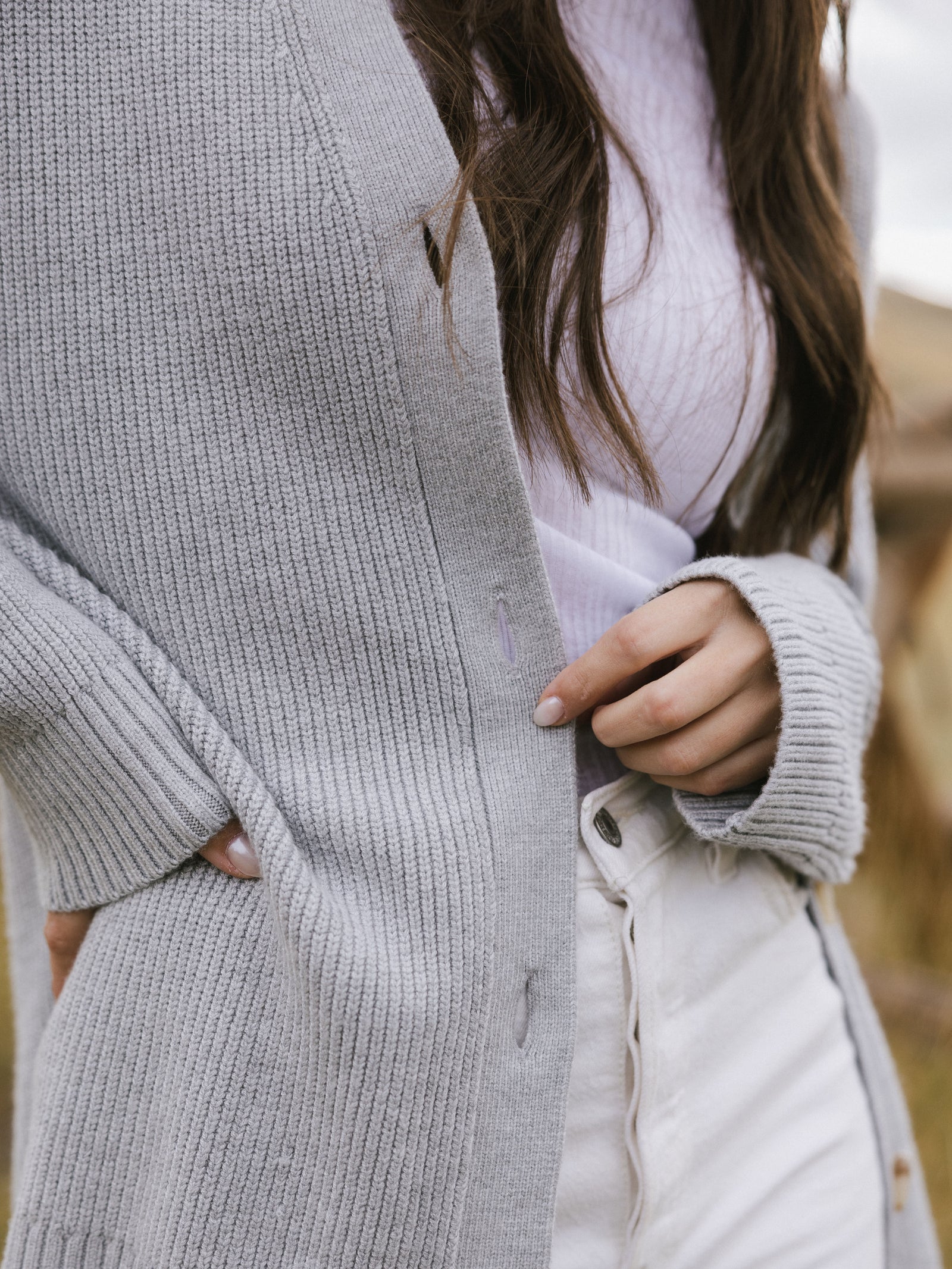 A close-up of woman wearing Cozy Earth Classic Cardigan in grey