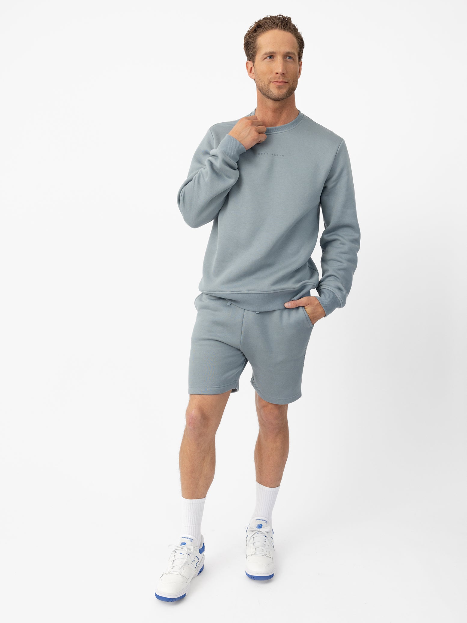 Man wearing Smokey Blue CityScape Shorts with white background