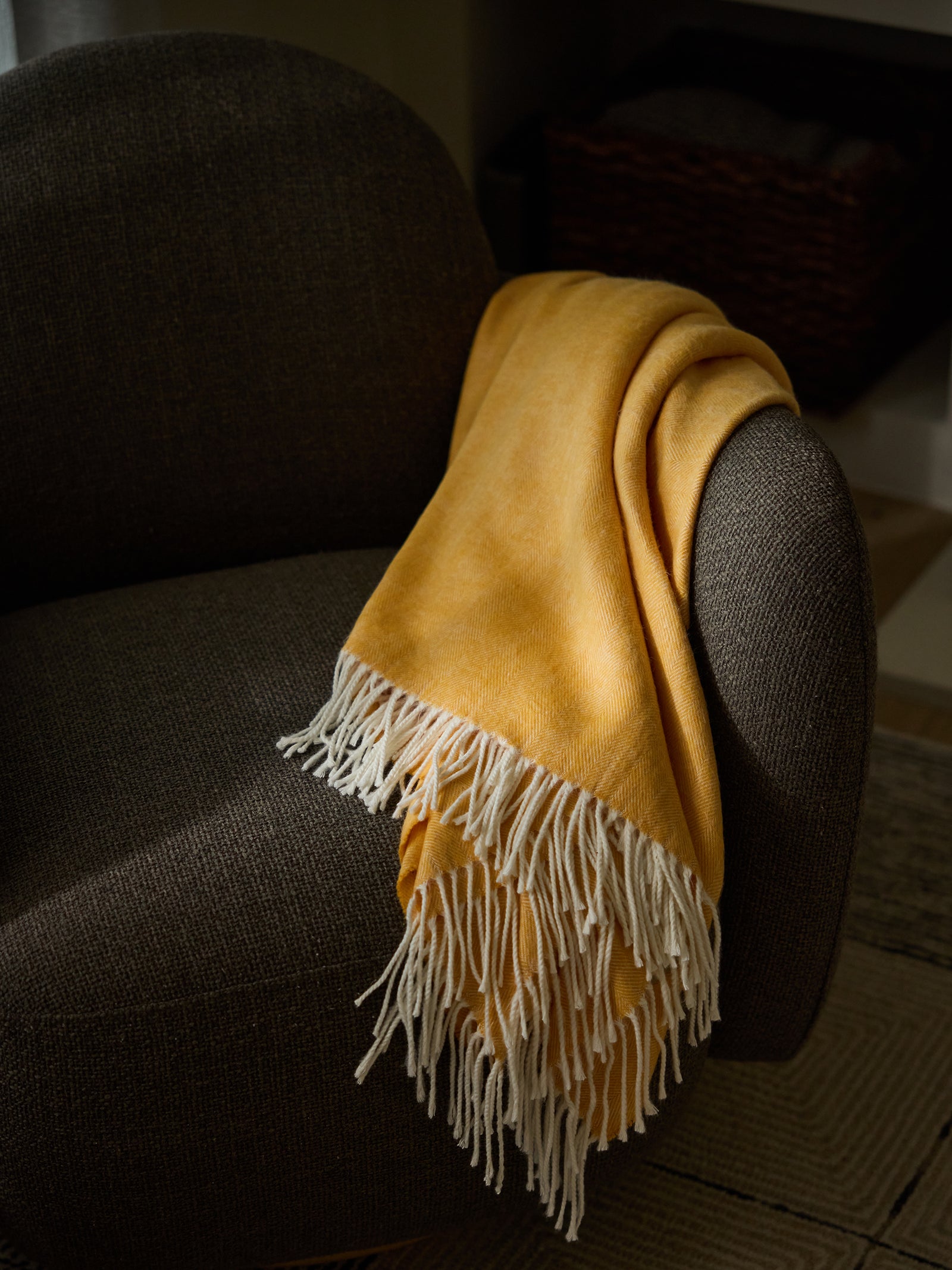 Sunflower herringbone tassel throw draped over recliner