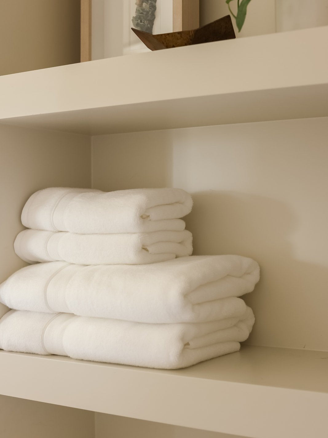White towels folded on shelf 