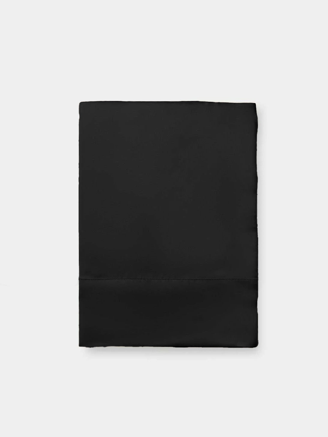 Flat lay of black pillowcase with white background 