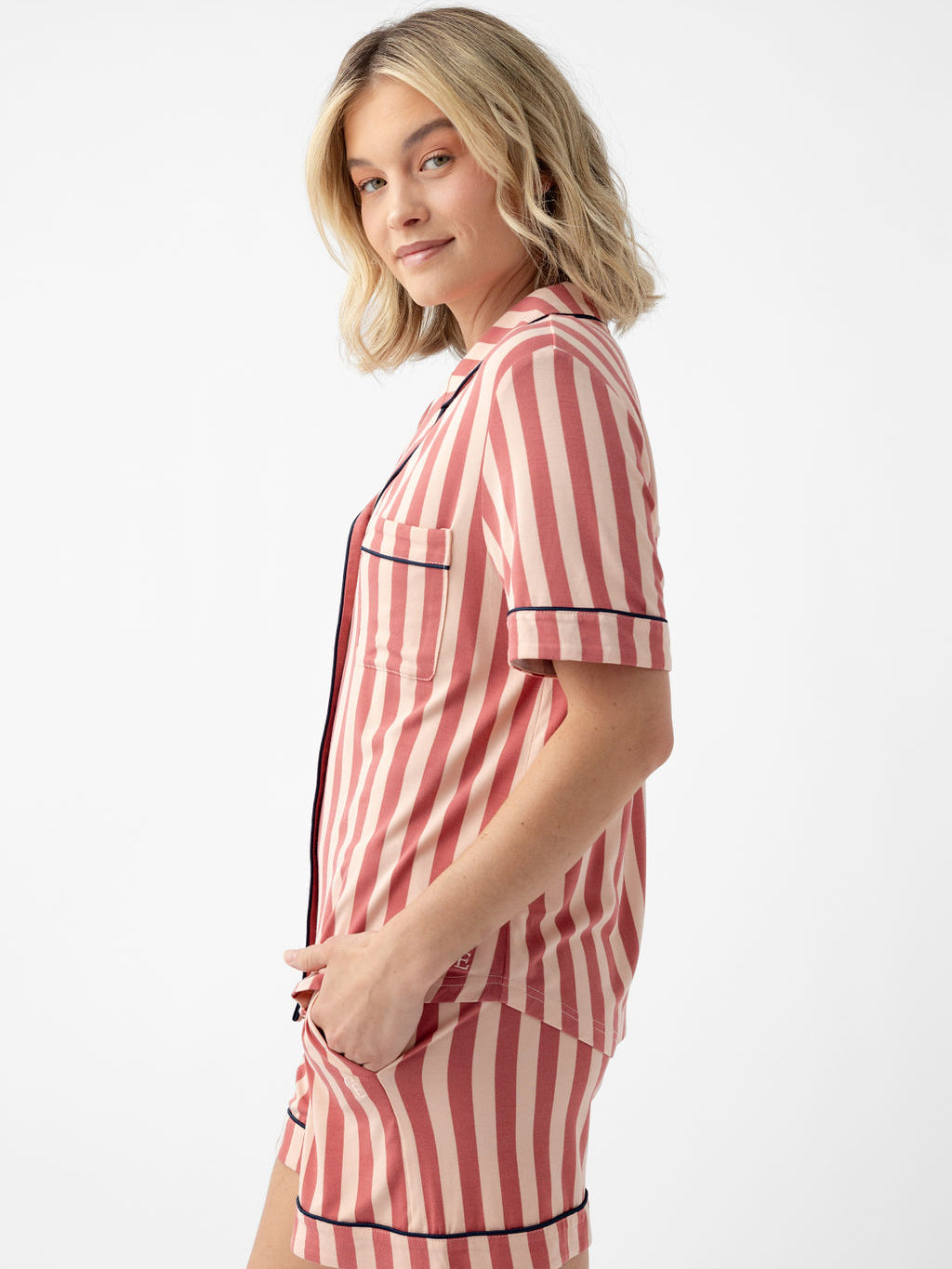 Woman in blush stripe short sleeve pajama set with white background 