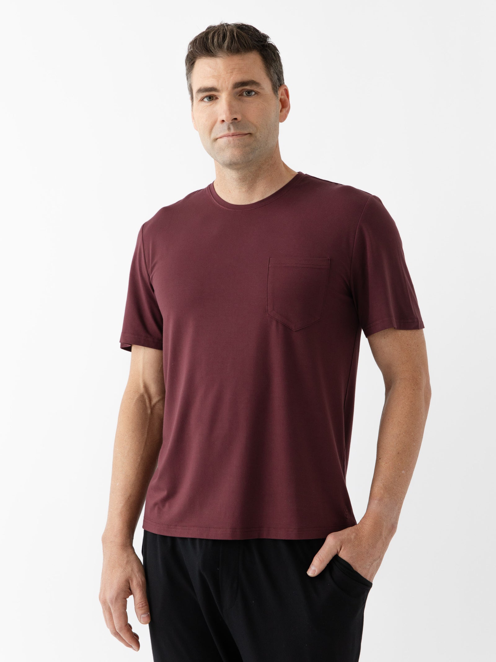 Burgundy Men's Stretch-Knit Bamboo Lounge Tee. A man is wearing the lounge tee in a well lit home.