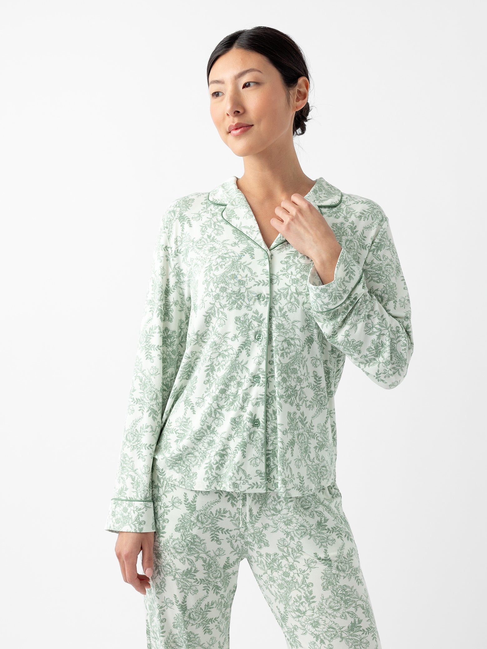 Woman wearing celadon toile pajama shirt with white background