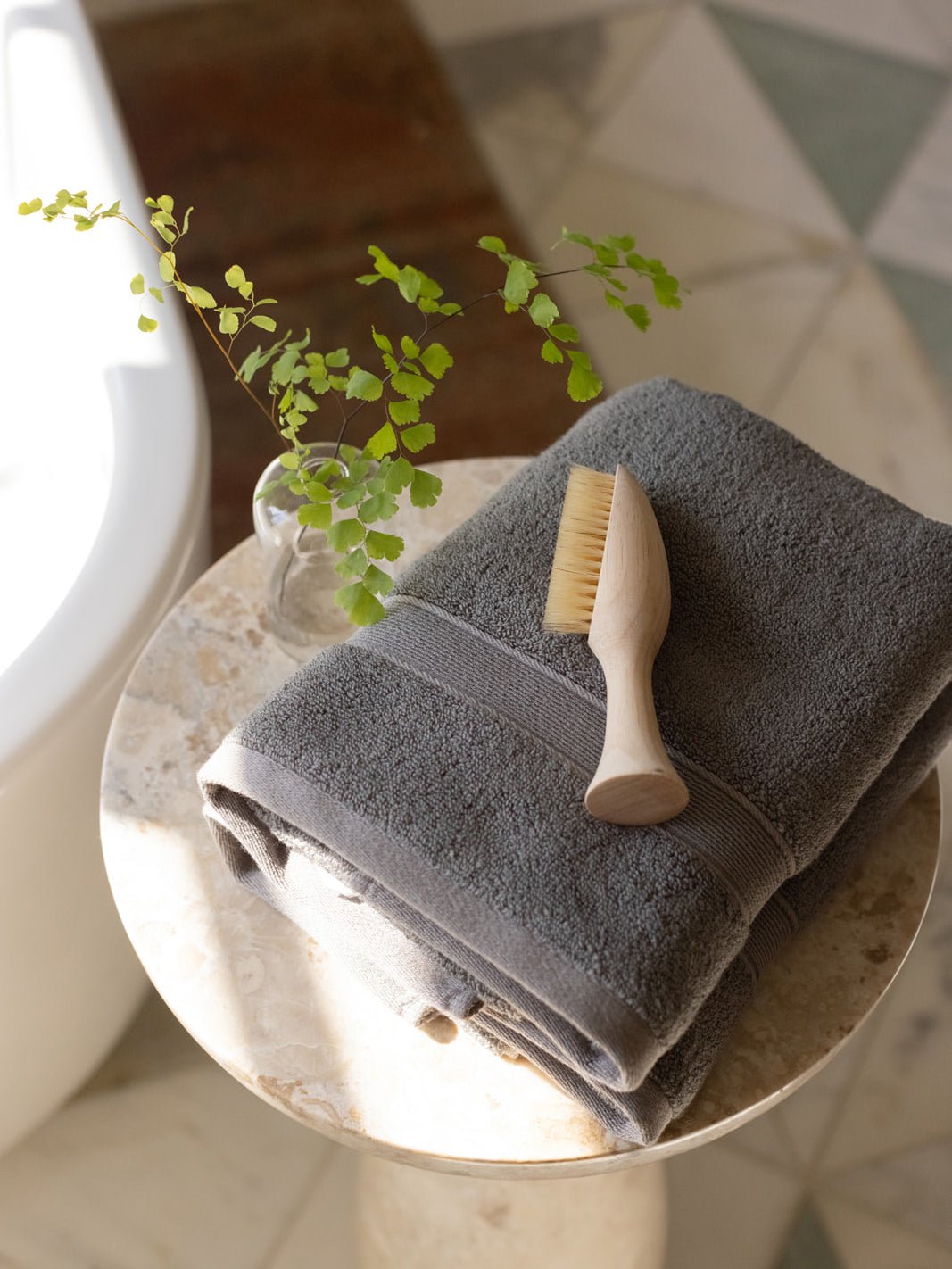 Charcoal hand towels on small table with brush 