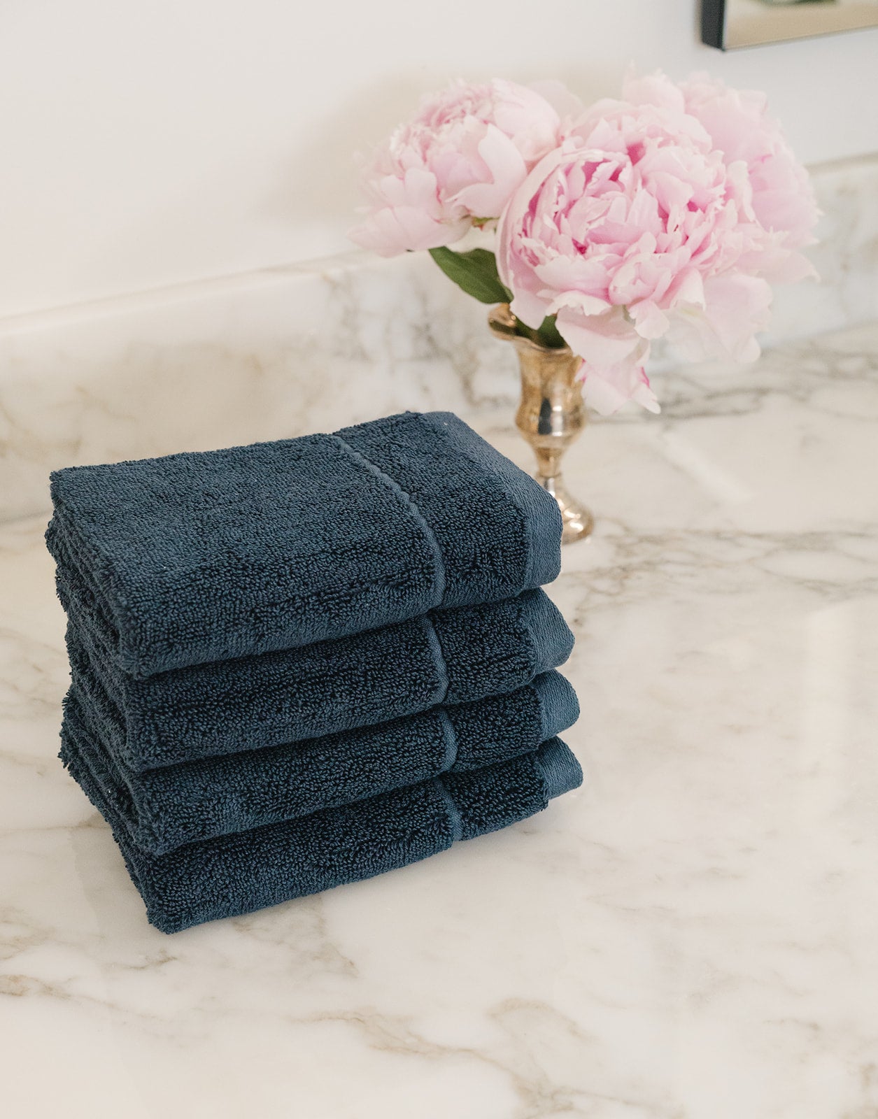 Dusk Premium Plush Wash Cloths. Photo of Premium Plush Wash Cloths taken with in a white bathroom with marble counter tops. 