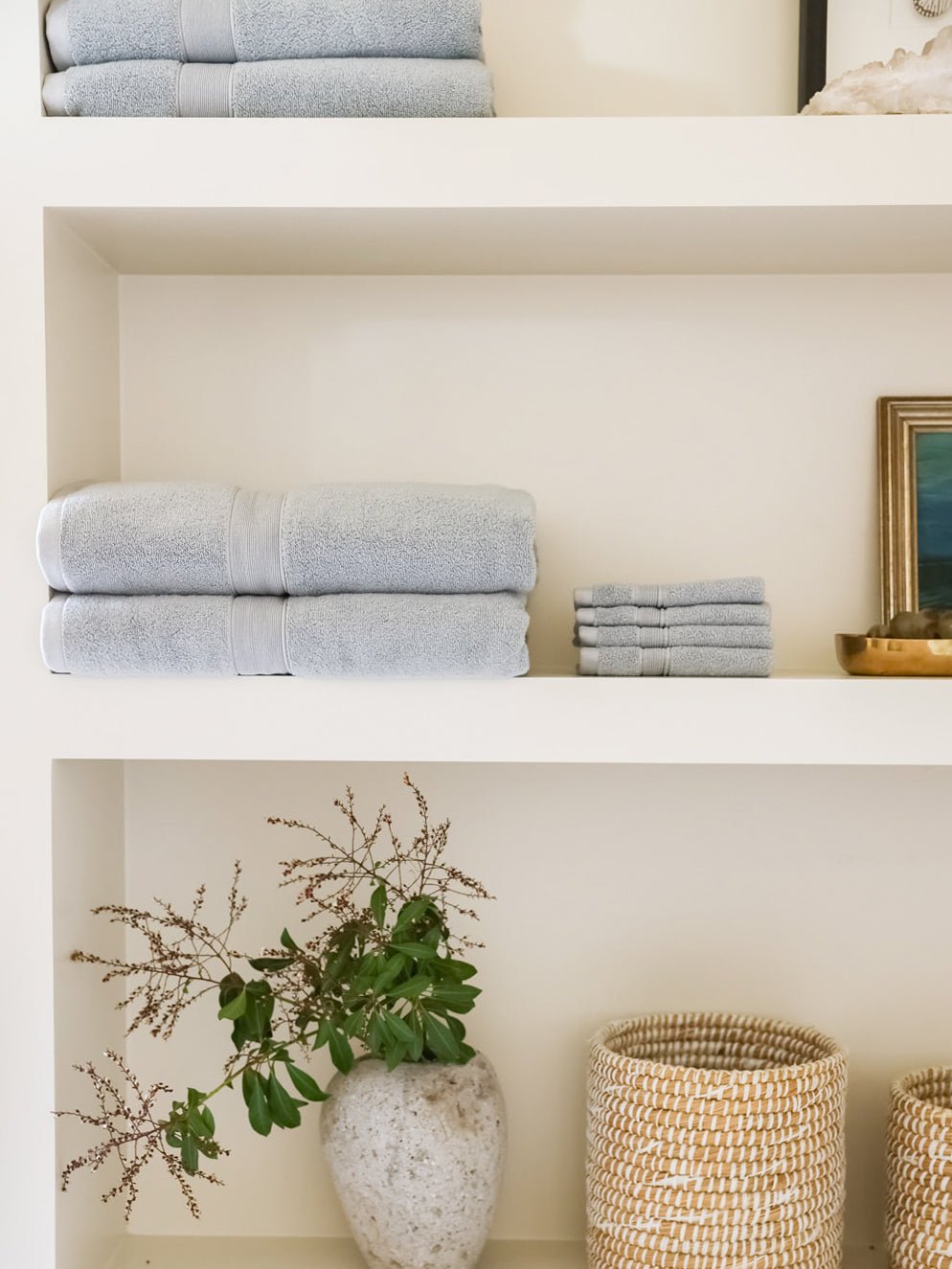 Harbor mist towels and washcloths folded on shelf 