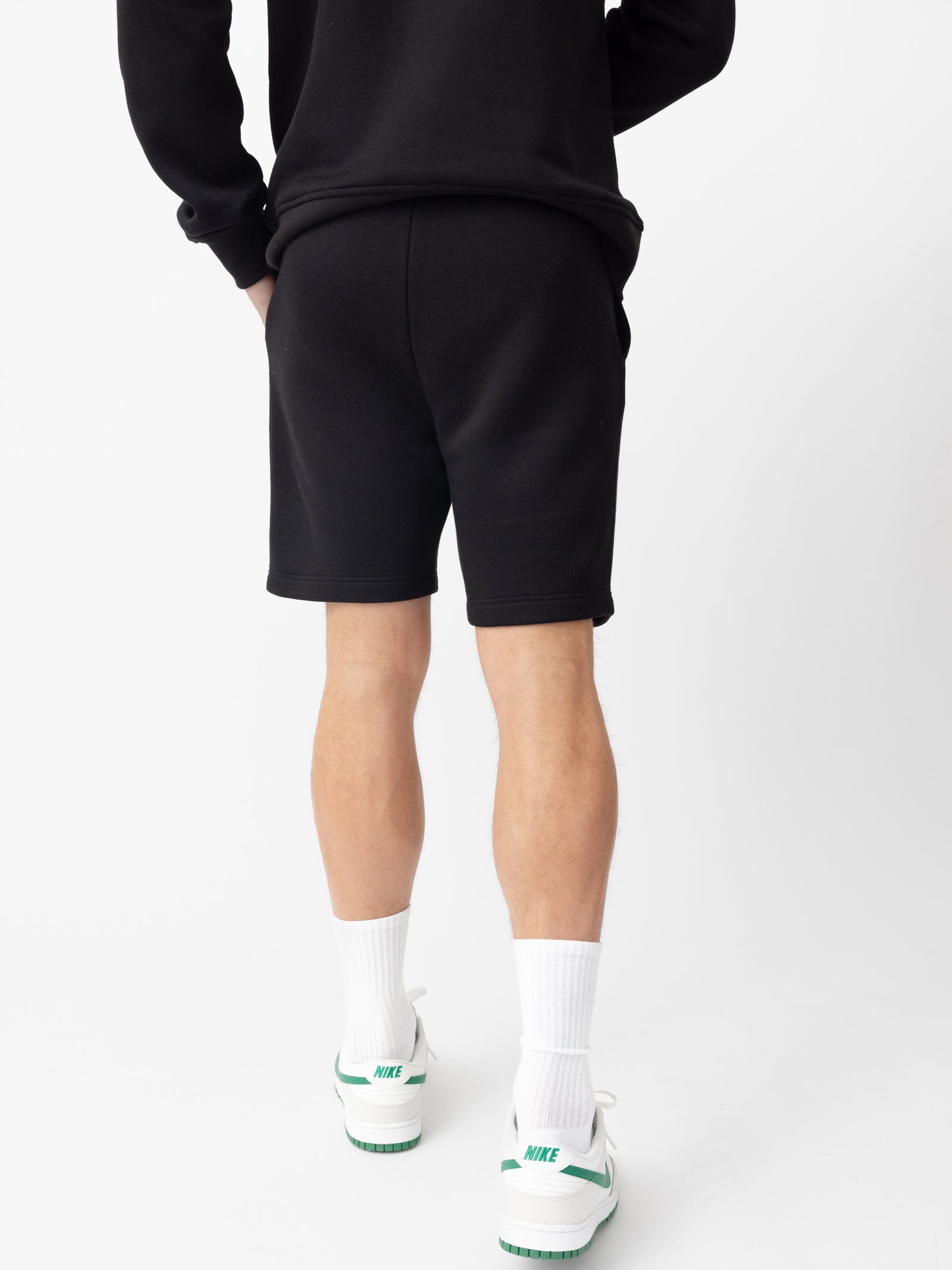 Back of man wearing black cityscape shorts