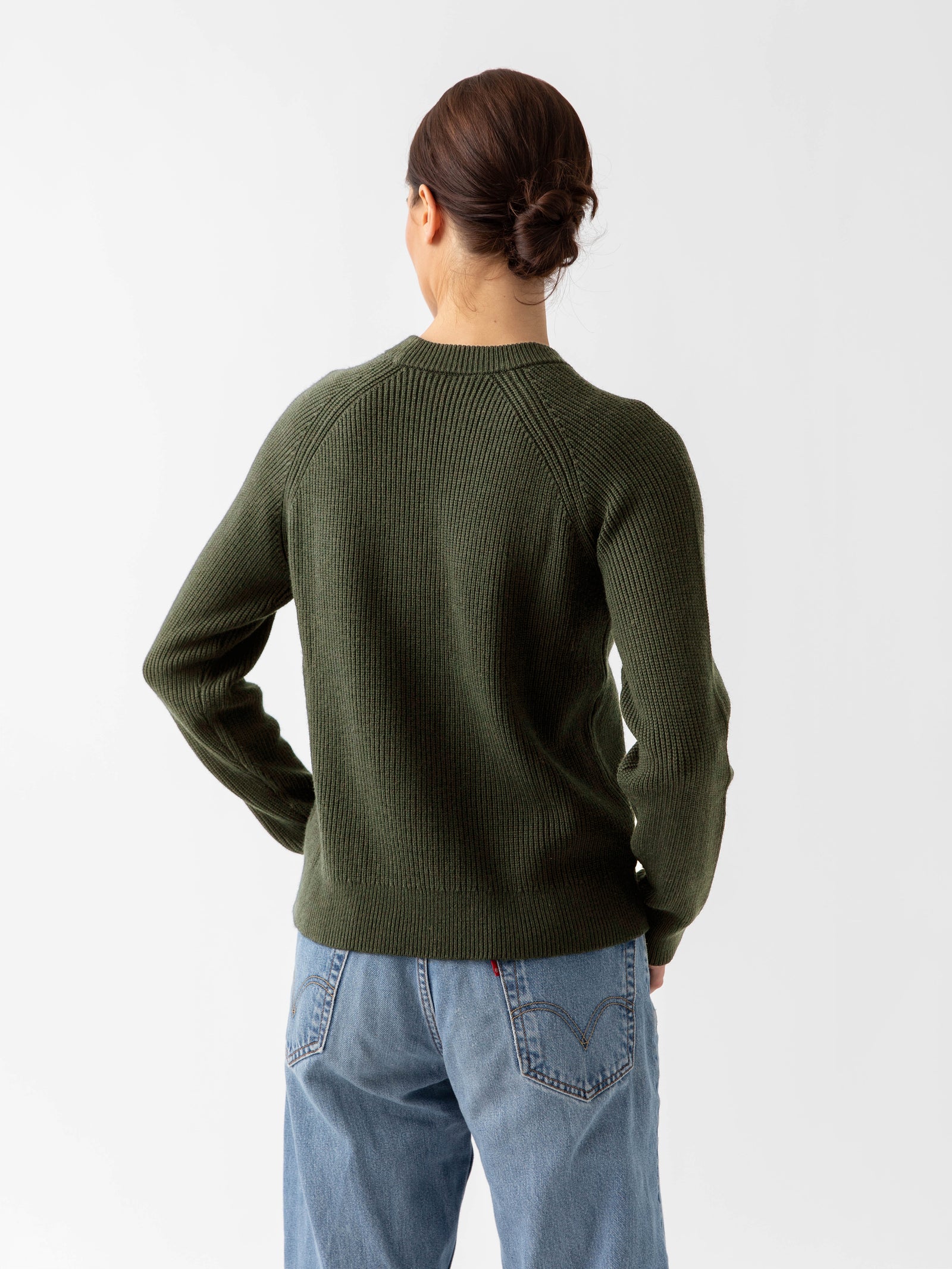 Back of woman wearing juniper classic crewneck and jeans with white background