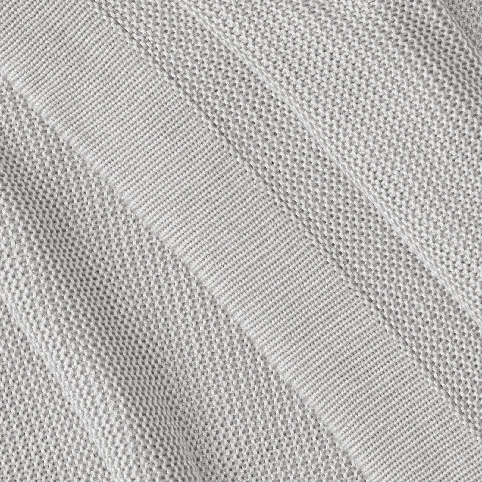 Close up of light grey cloud knit blanket