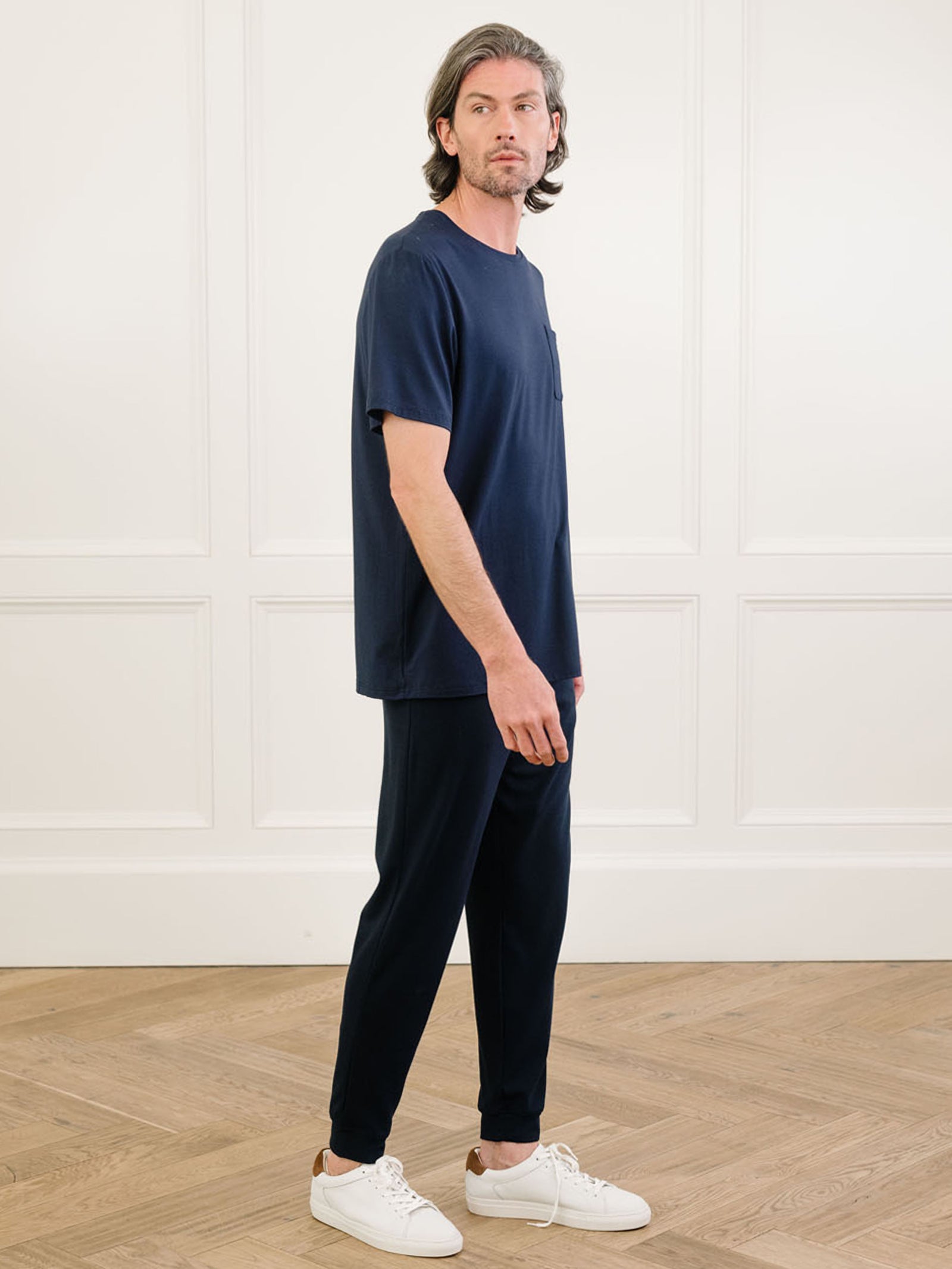 Navy Men's Stretch-Knit Bamboo Lounge Tee. A man is wearing the lounge tee in a well lit home.