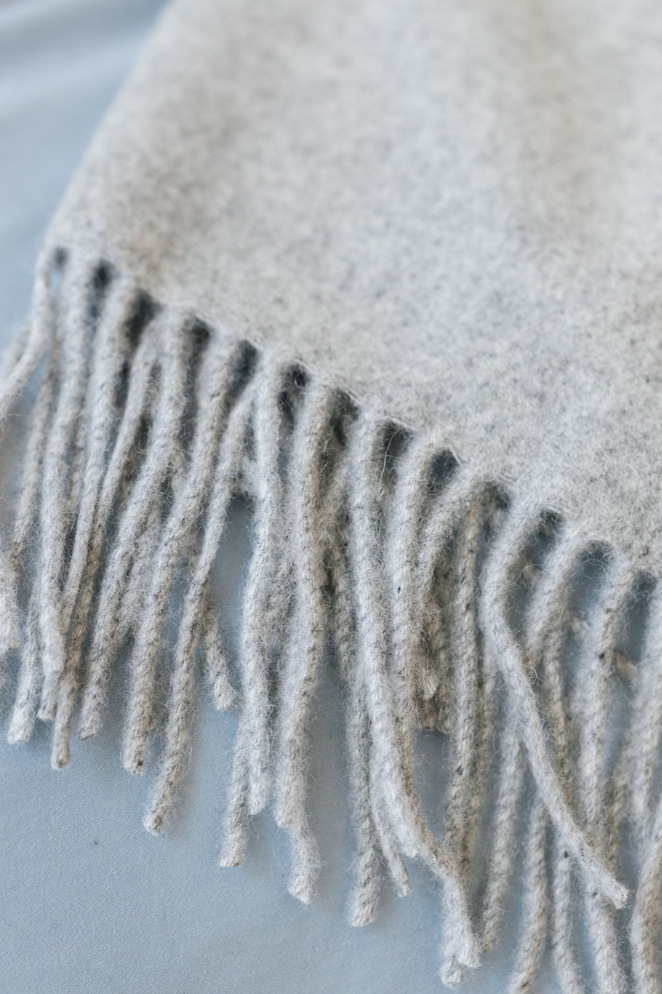 Close up of tassels on pebble cashmere throw 