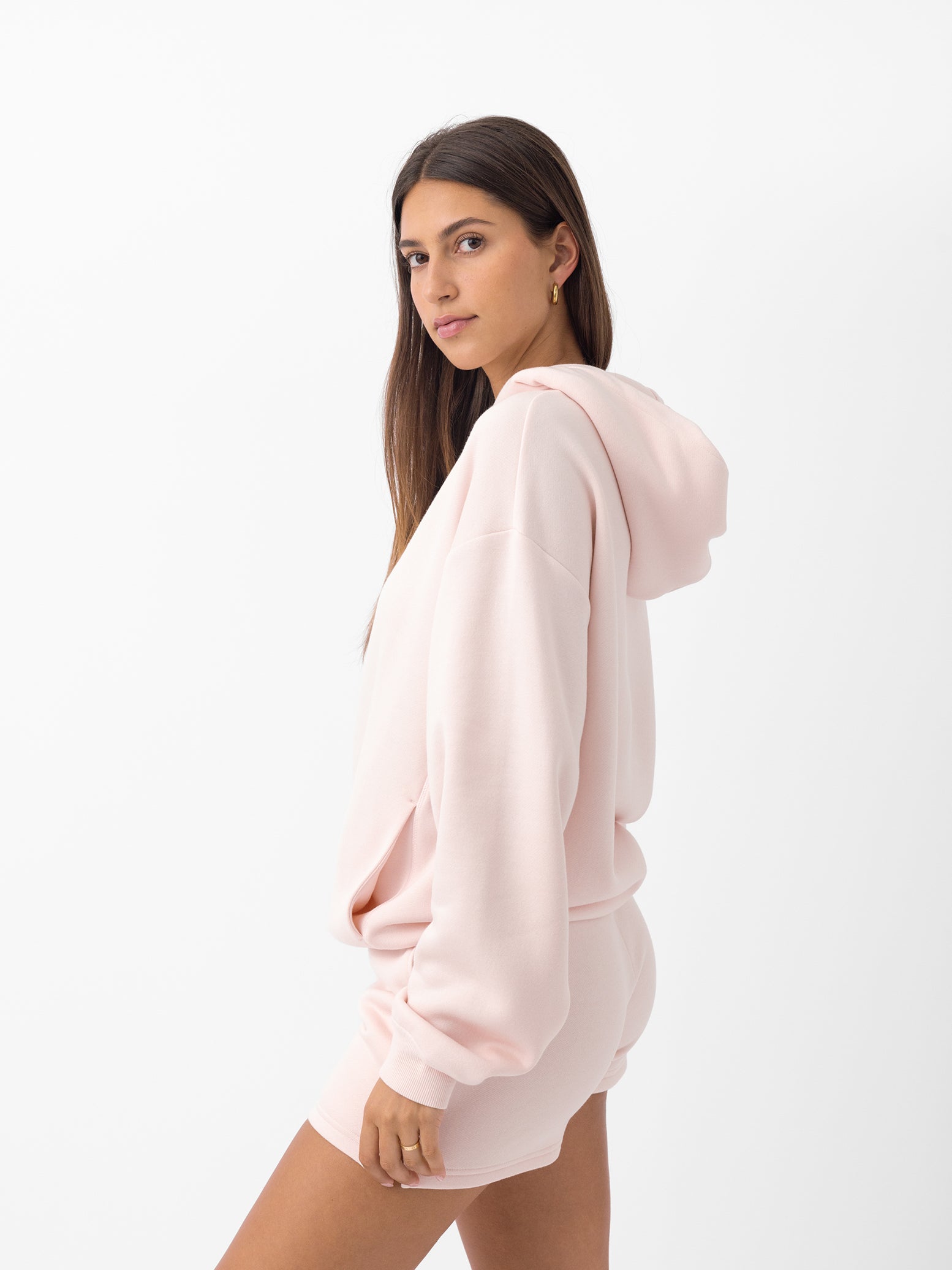 Side view of woman wearing peony cityscape hoodie with white background 