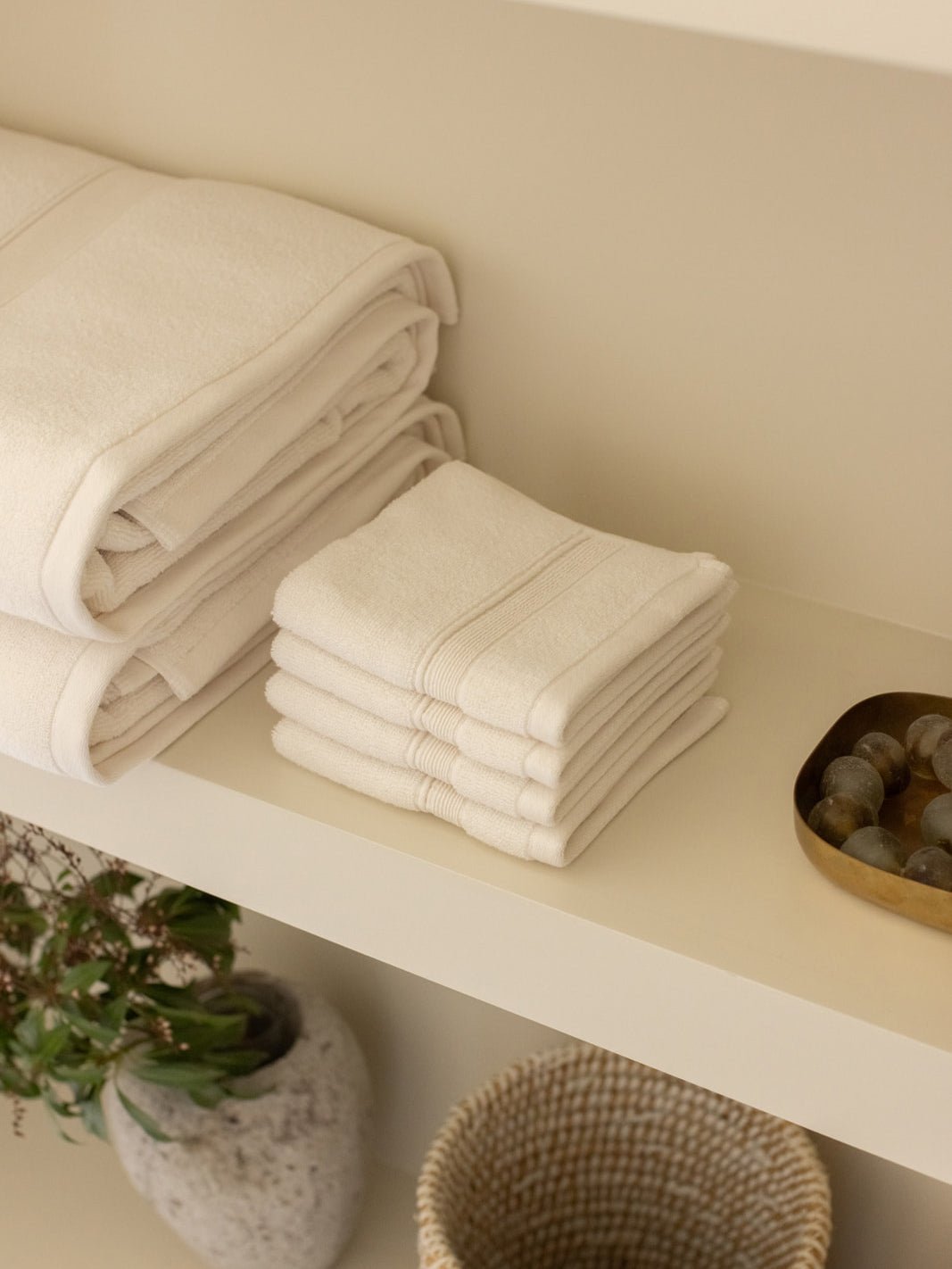 Seashell washcloths folded on shelf 