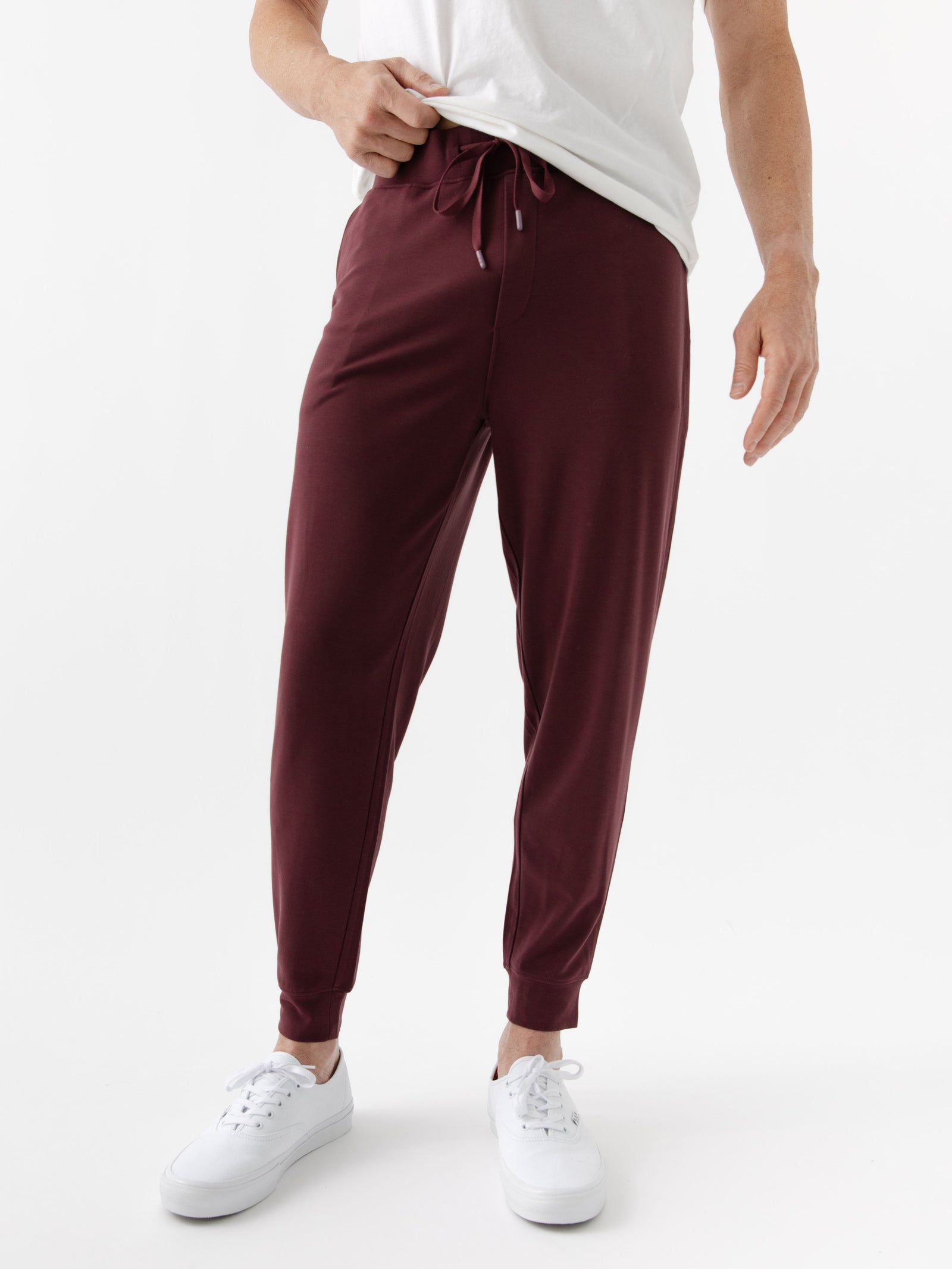 Burgundy/Light GreyMen's Bamboo Jogger Set. There is a man wearing the jogger set. He is standing in a well lit room in a home.