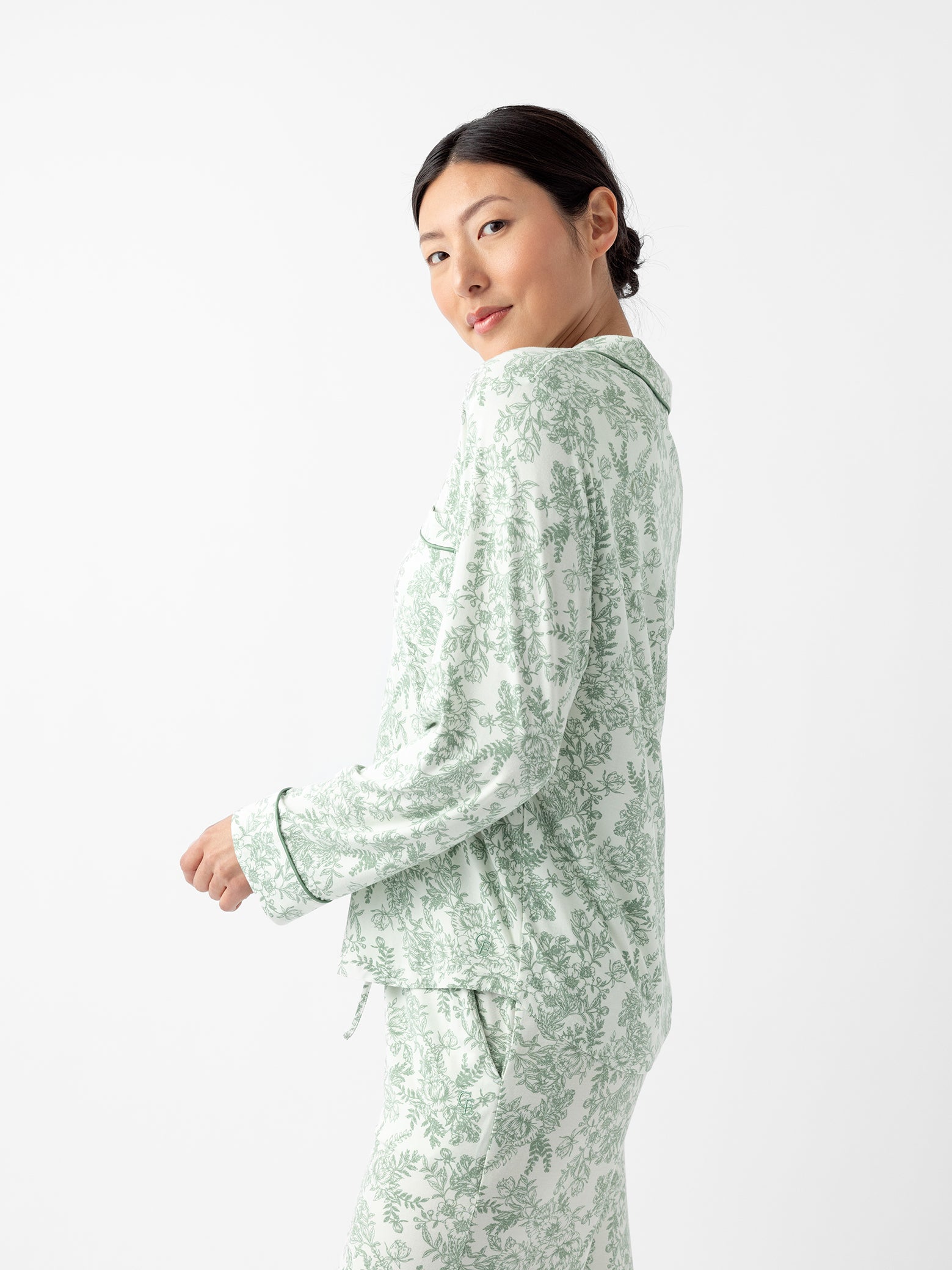 Side view of woman in celadon toile pajama top