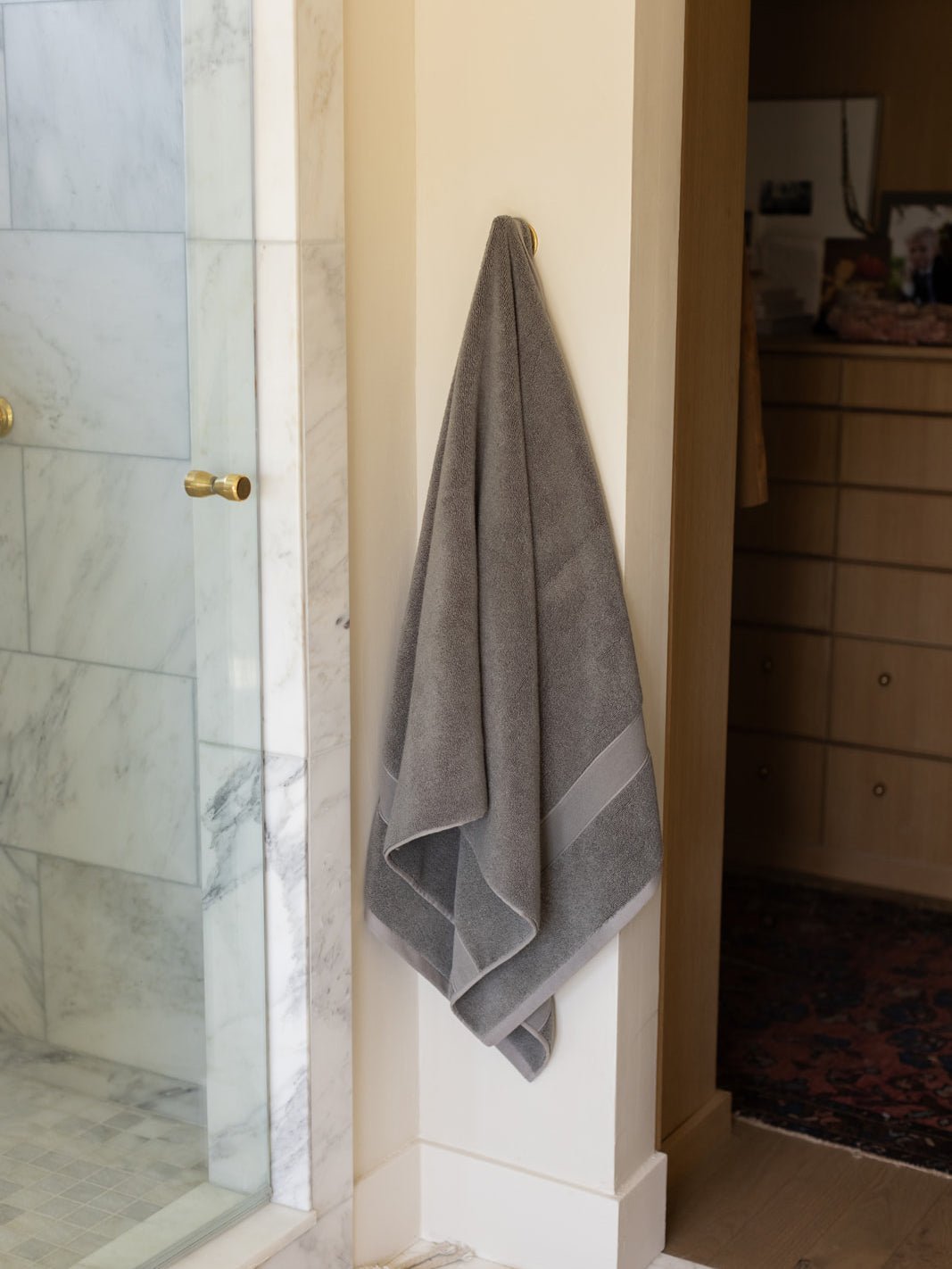 Charcoal luxe bath sheet hanging next to shower 