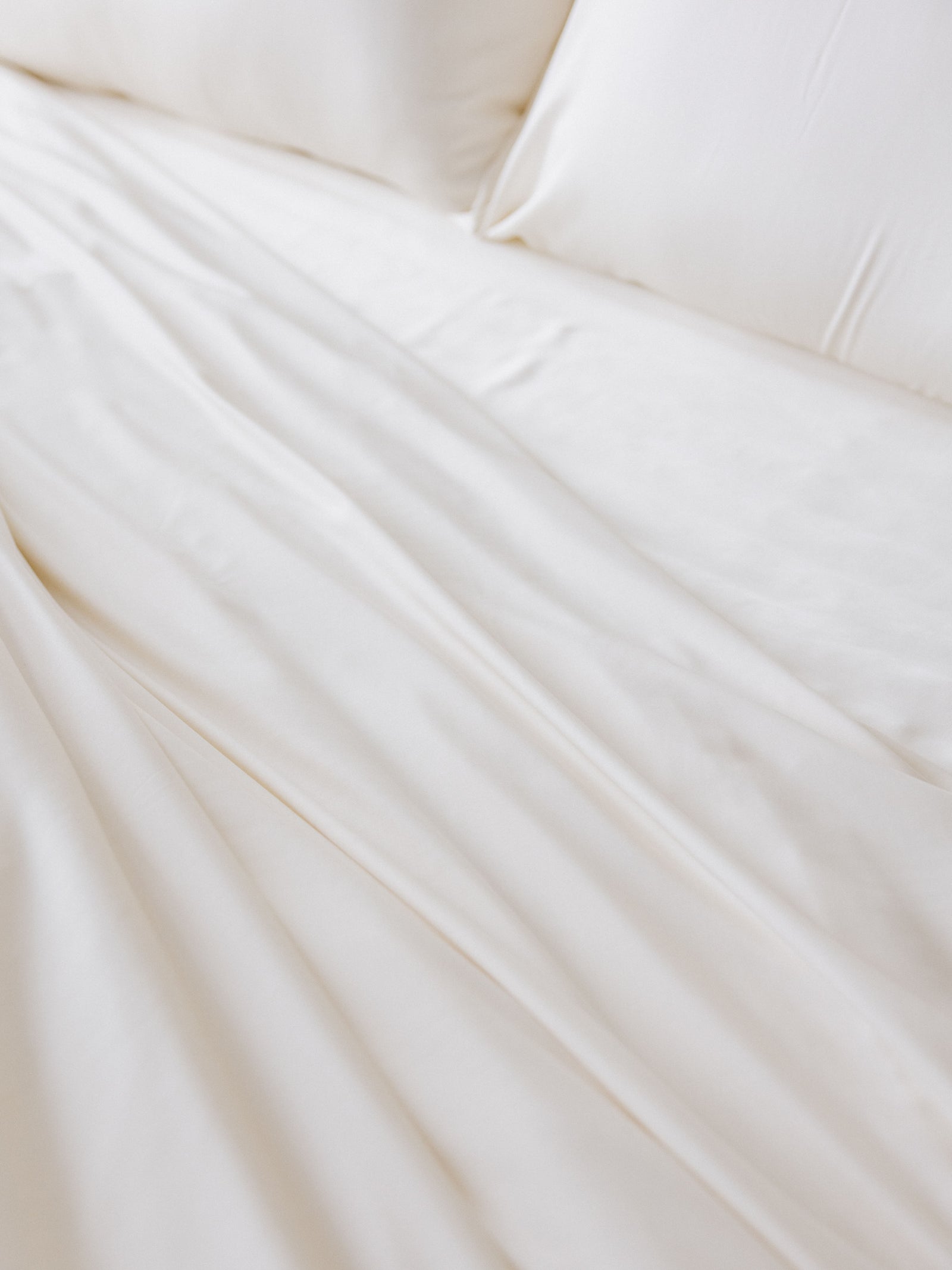 Close up of creme bedding on bed
