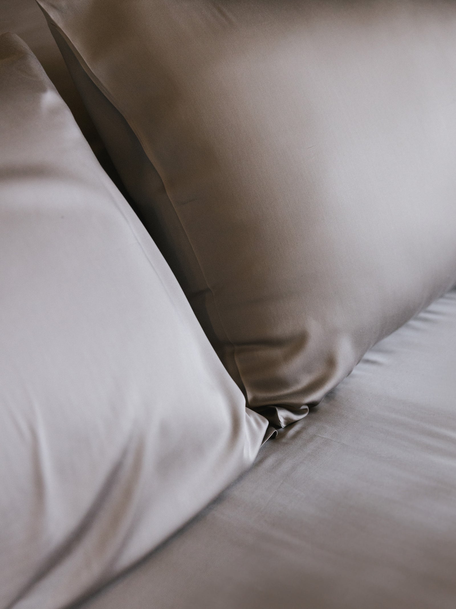 Close up of dove grey pillowcases on a bed standard/king/body
