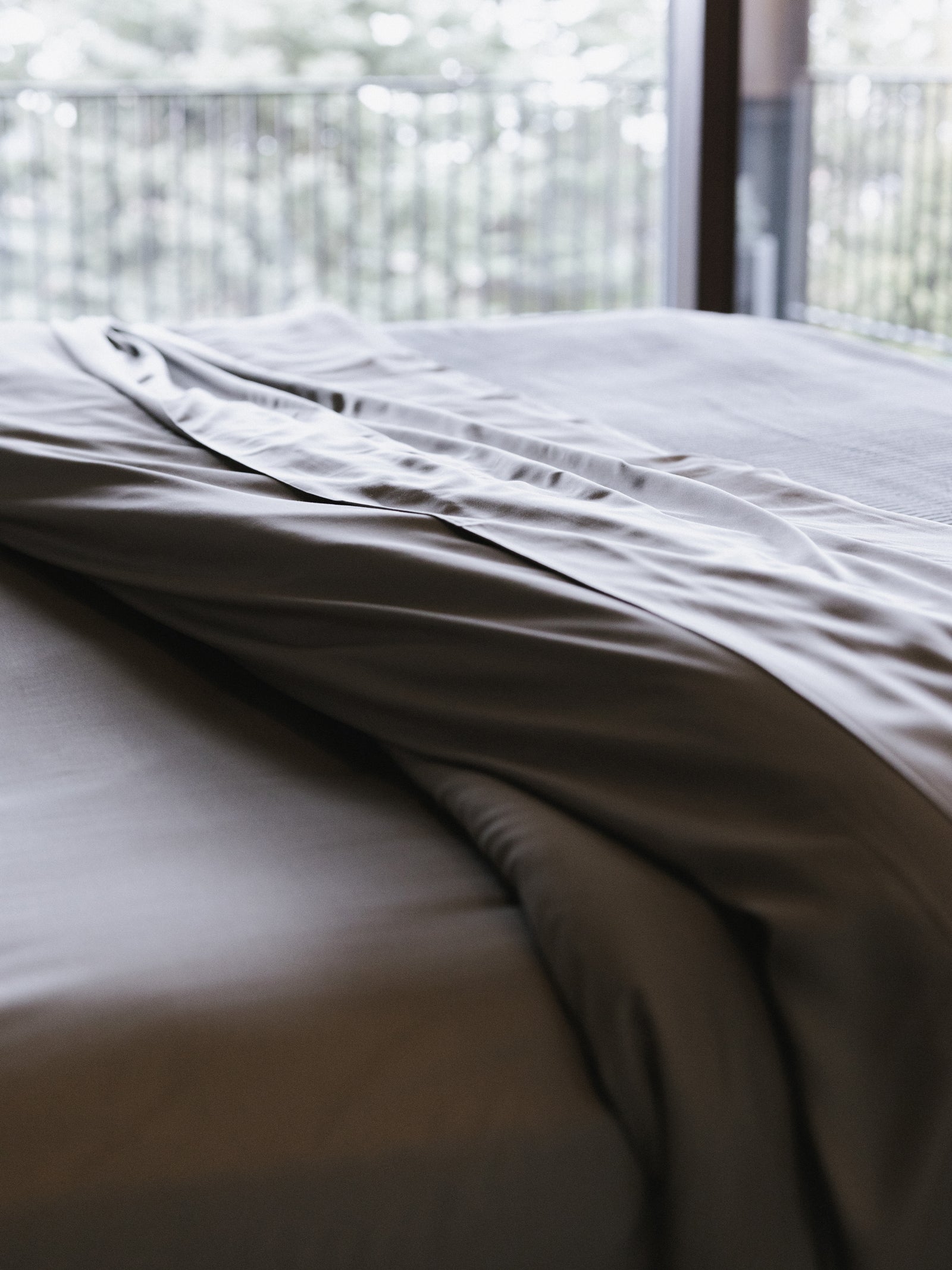 Comforter with dove grey duvet cover on bed 