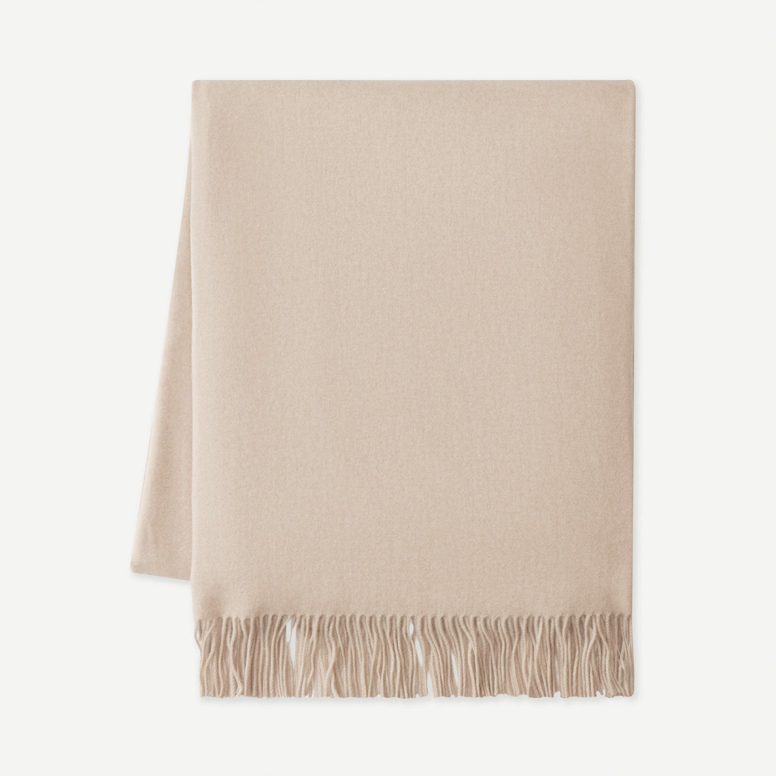 Flat lay of dune tassel throw with white background 