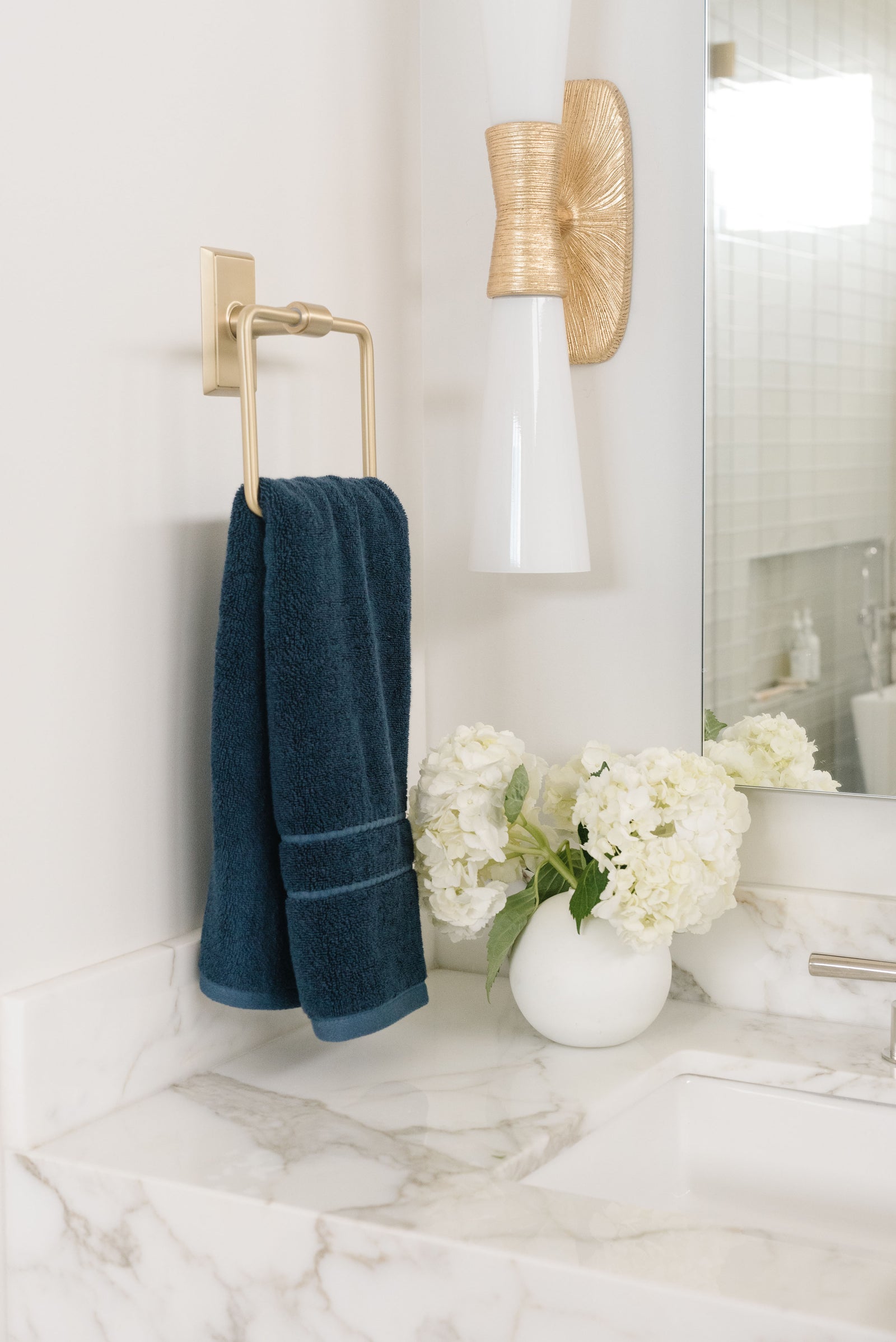 Premium Plush Hand Towel in the color Dusk. Photo of Dusk Premium Plush Hand Towel taken in a bathroom. One Premium Plush Hand Towel is hanging from a towel ring.