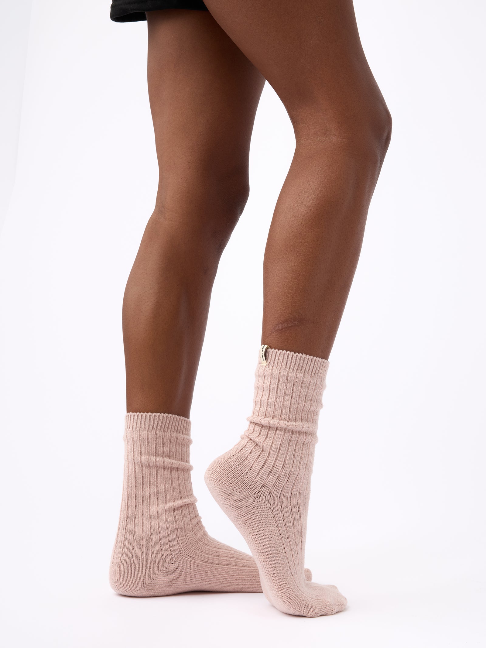Person turned to the side wearing Cozy Earth Plush Lounge Sock 1-Pack in Dusty Rose