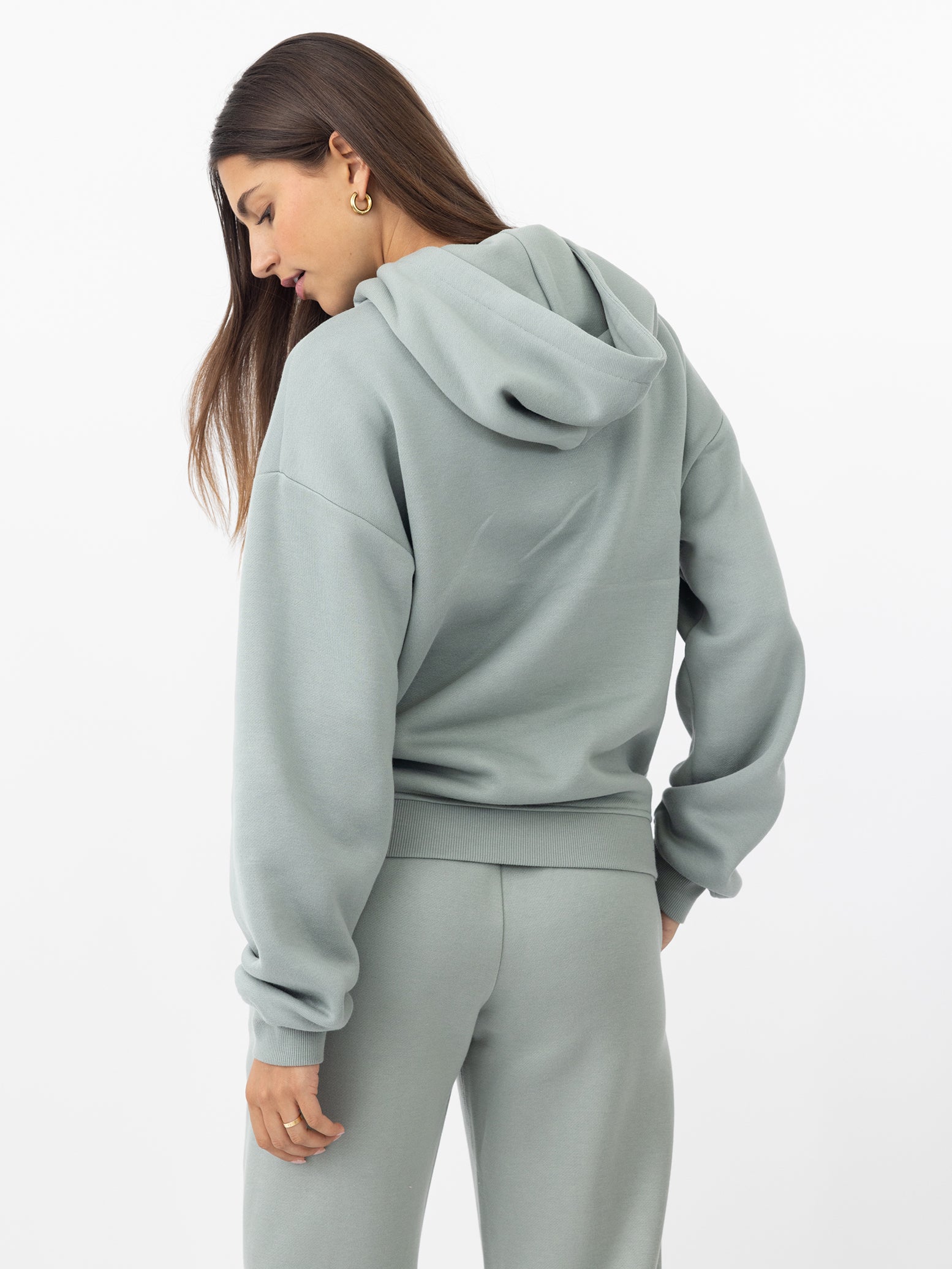 Back of woman wearing haze cityscape hoodie with white background 