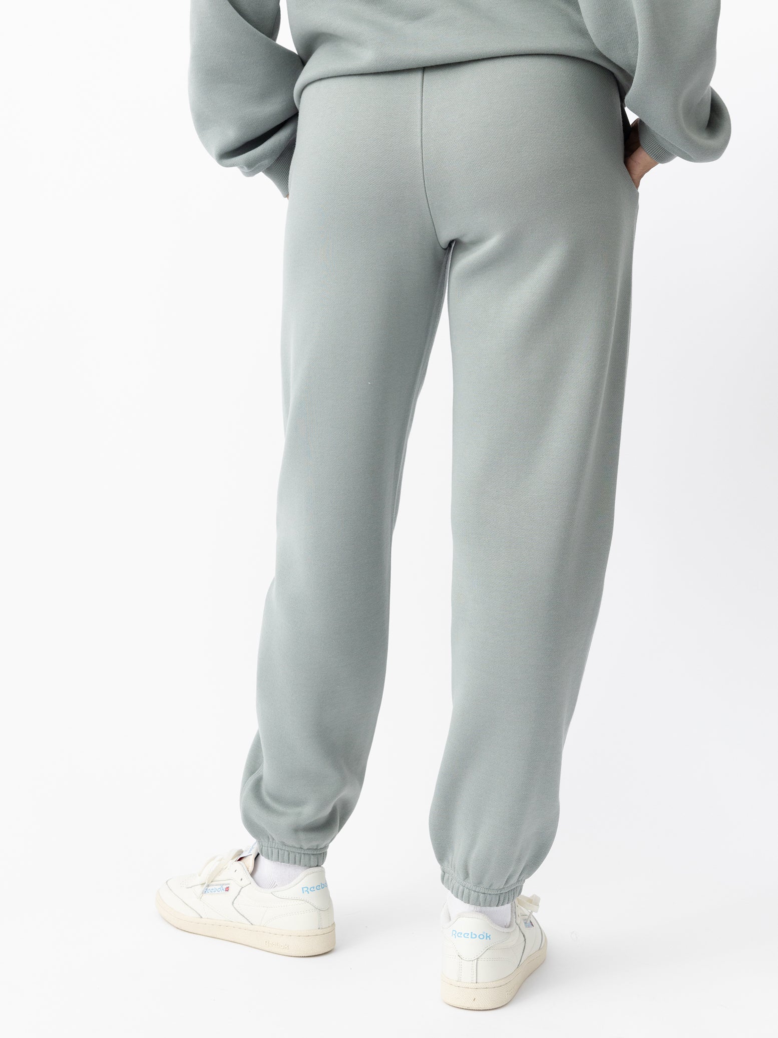 Haze CityScape Joggers. The Joggers are being worn by a female model. The photo is taken from the waist down with the models hand in the pocket of the joggers. The back ground is white. 