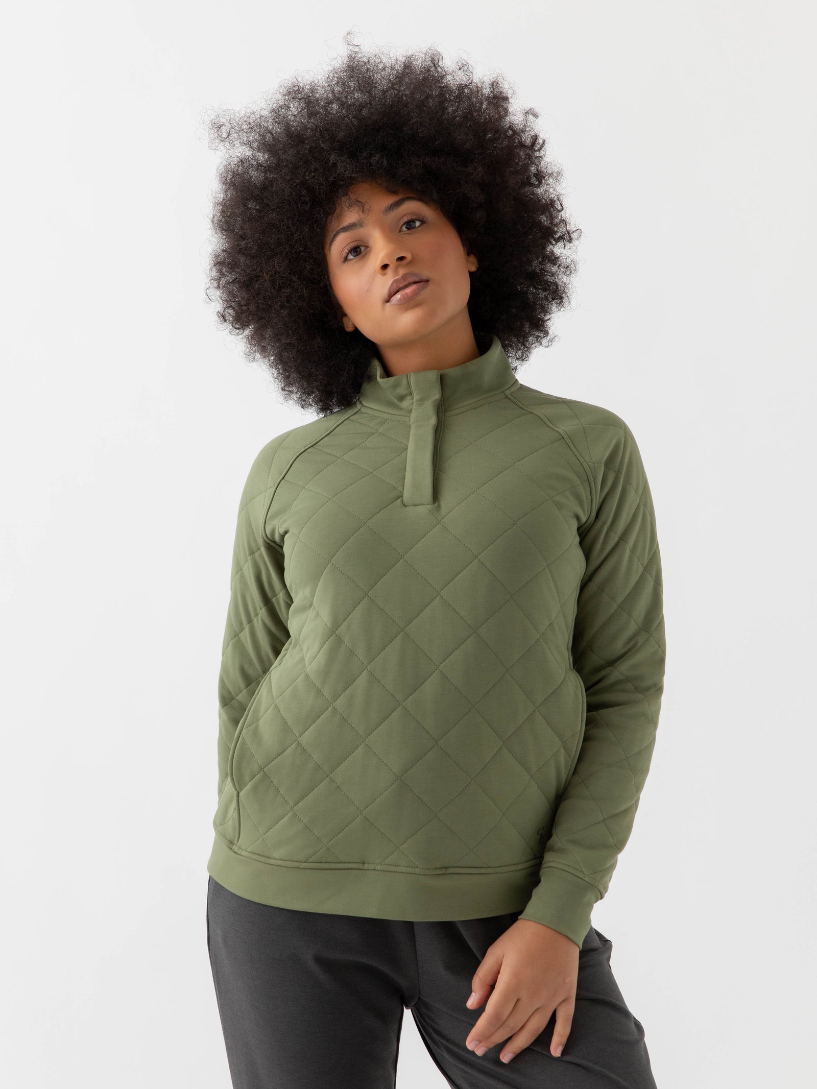 Woman wearing a green Cozy Earth Brushed Bamboo Quilted Pullover against a white background