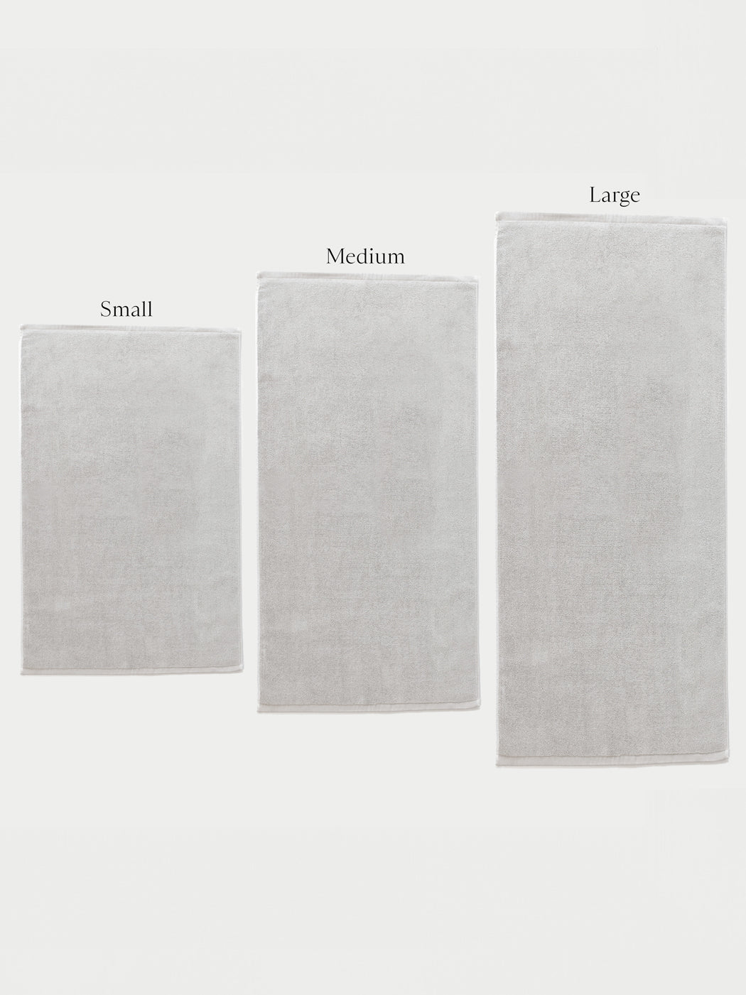 Three Cozy Earth Loop Terry Bath Mats in small, medium, and large are displayed side by side against a white background, each labeled above with its size.