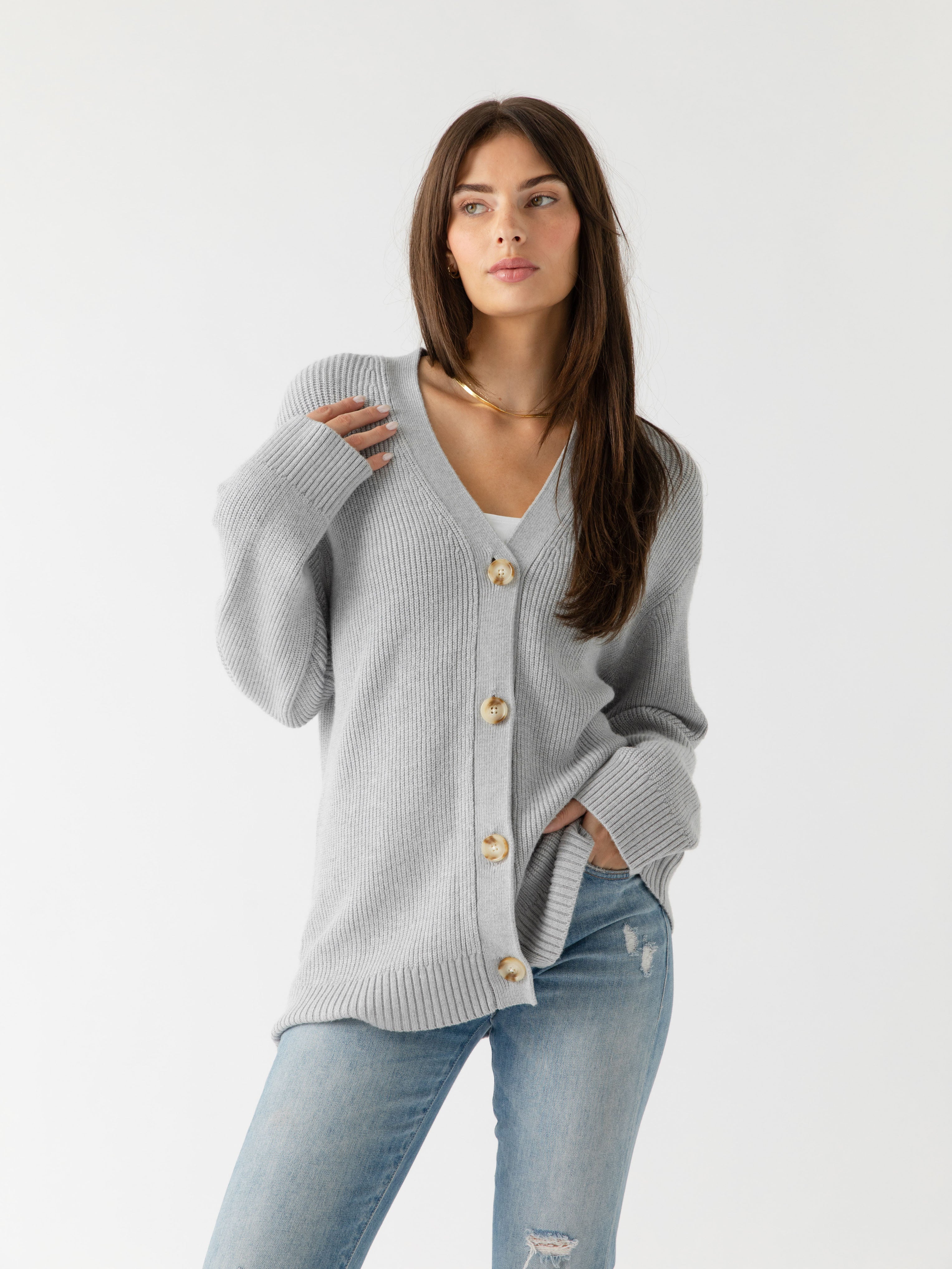 A woman wearing Cozy Earth Classic Cardigan in grey stands in front of a white background |Color:Light Grey