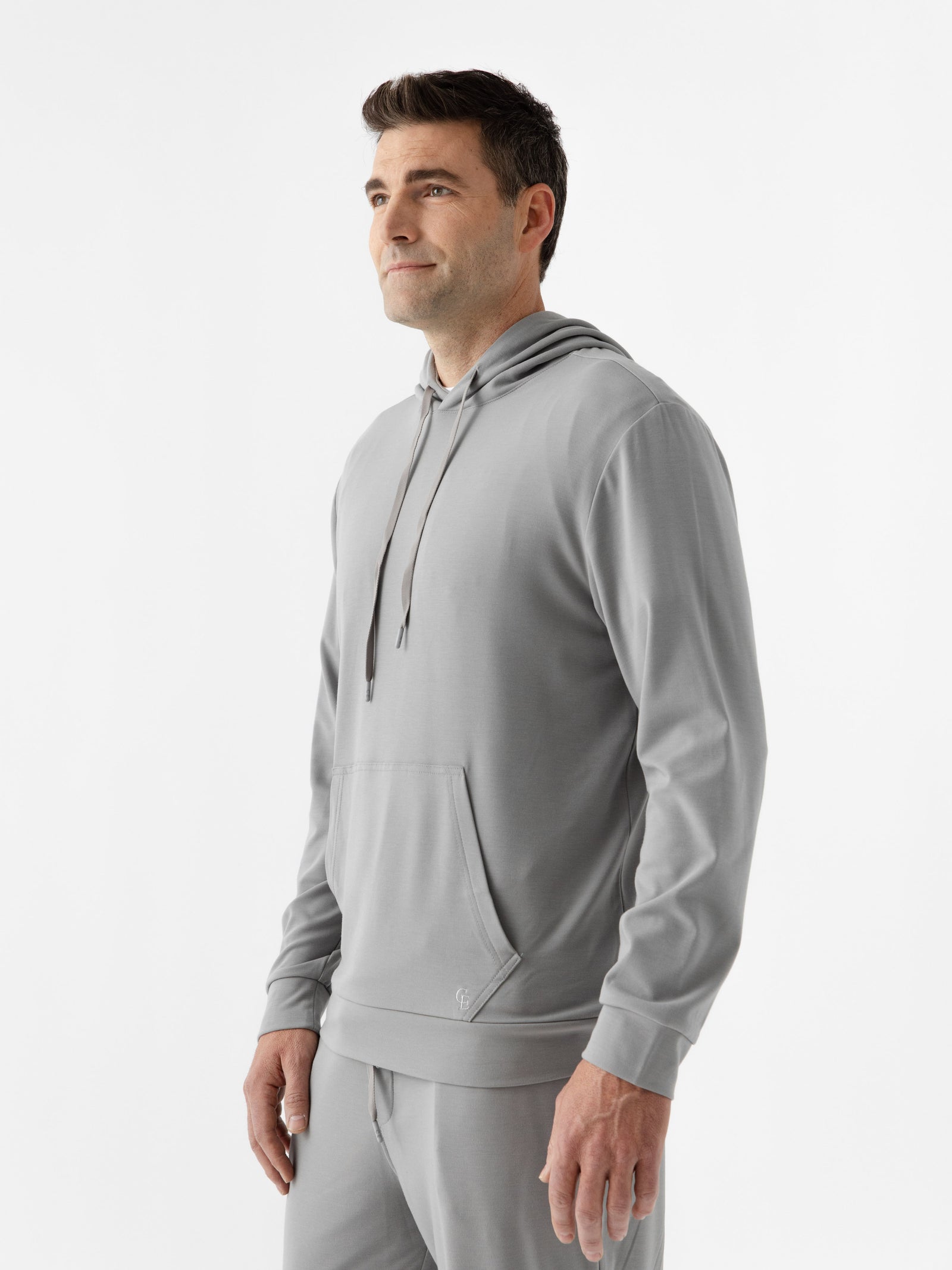 Stone Bamboo Hoodie worn by man standing in front of white background.