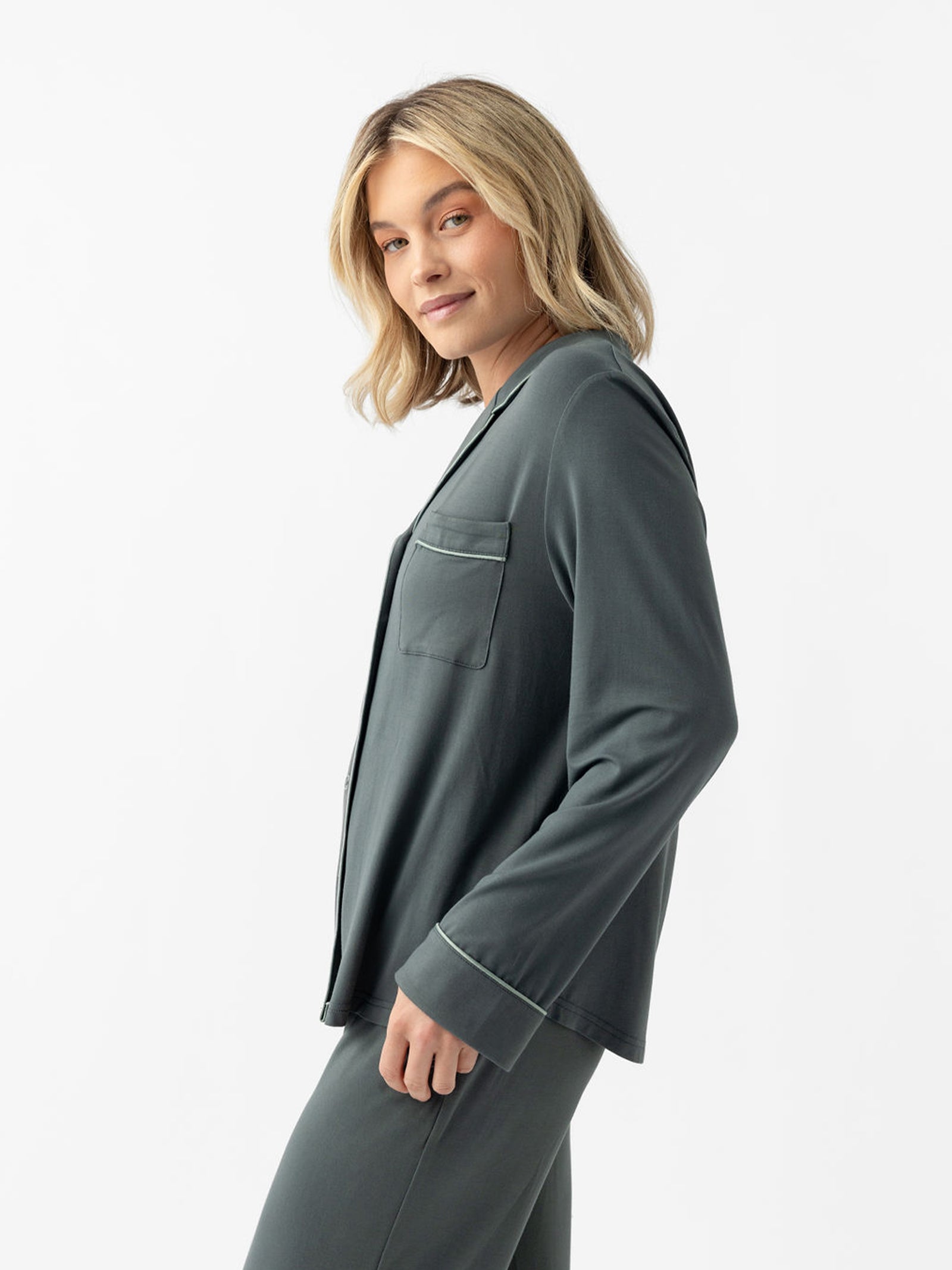 Side view of woman wearing storm pajamas with white background