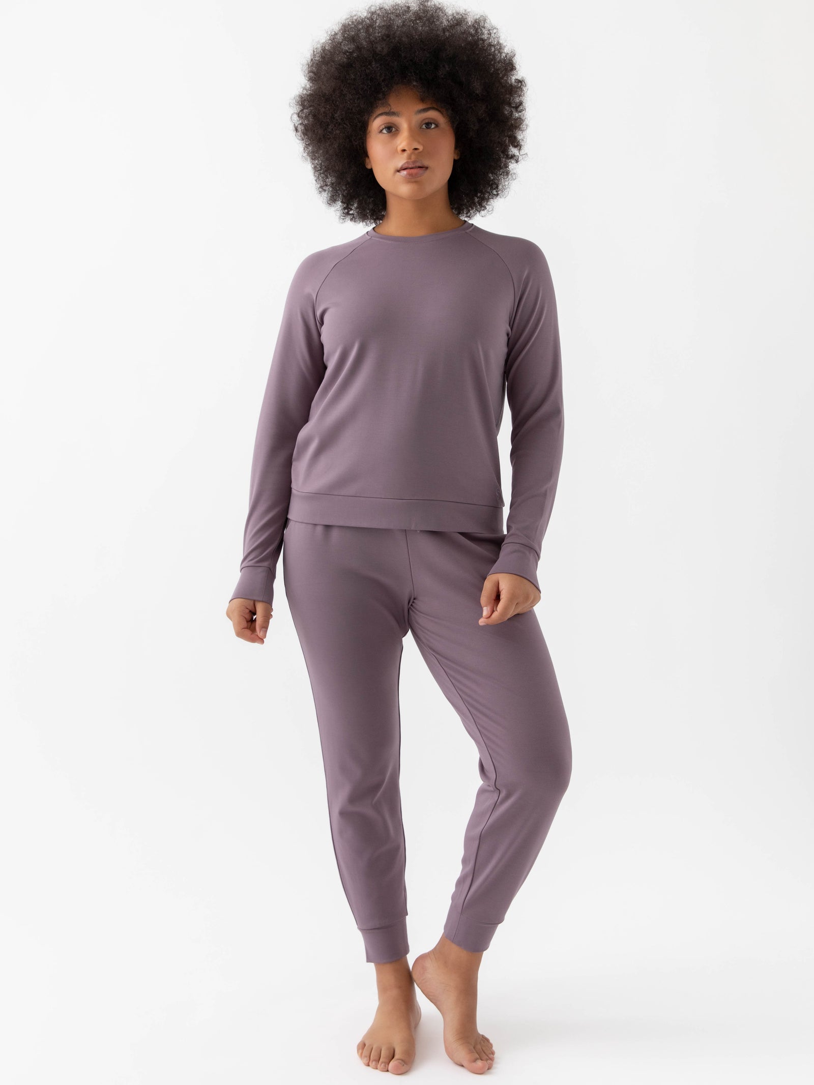 Twilight Bamboo Jogger Set modeled by a woman. The photo was taken in a high contrast setting, showing off the colors and lines of the pajamas.