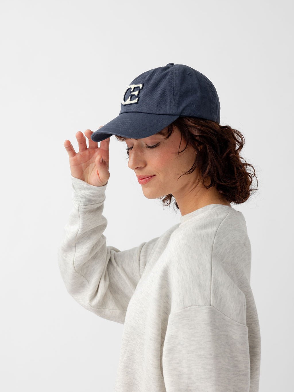 Side view of woman wearing washed navy vintage cap 