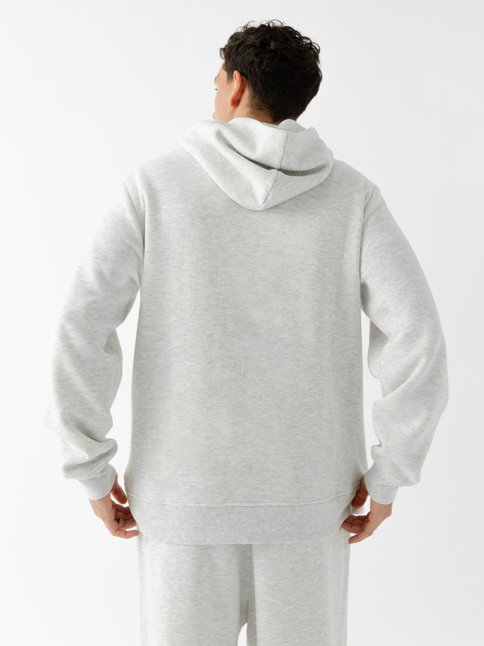Back of man wearing heather grey cityscape hoodie