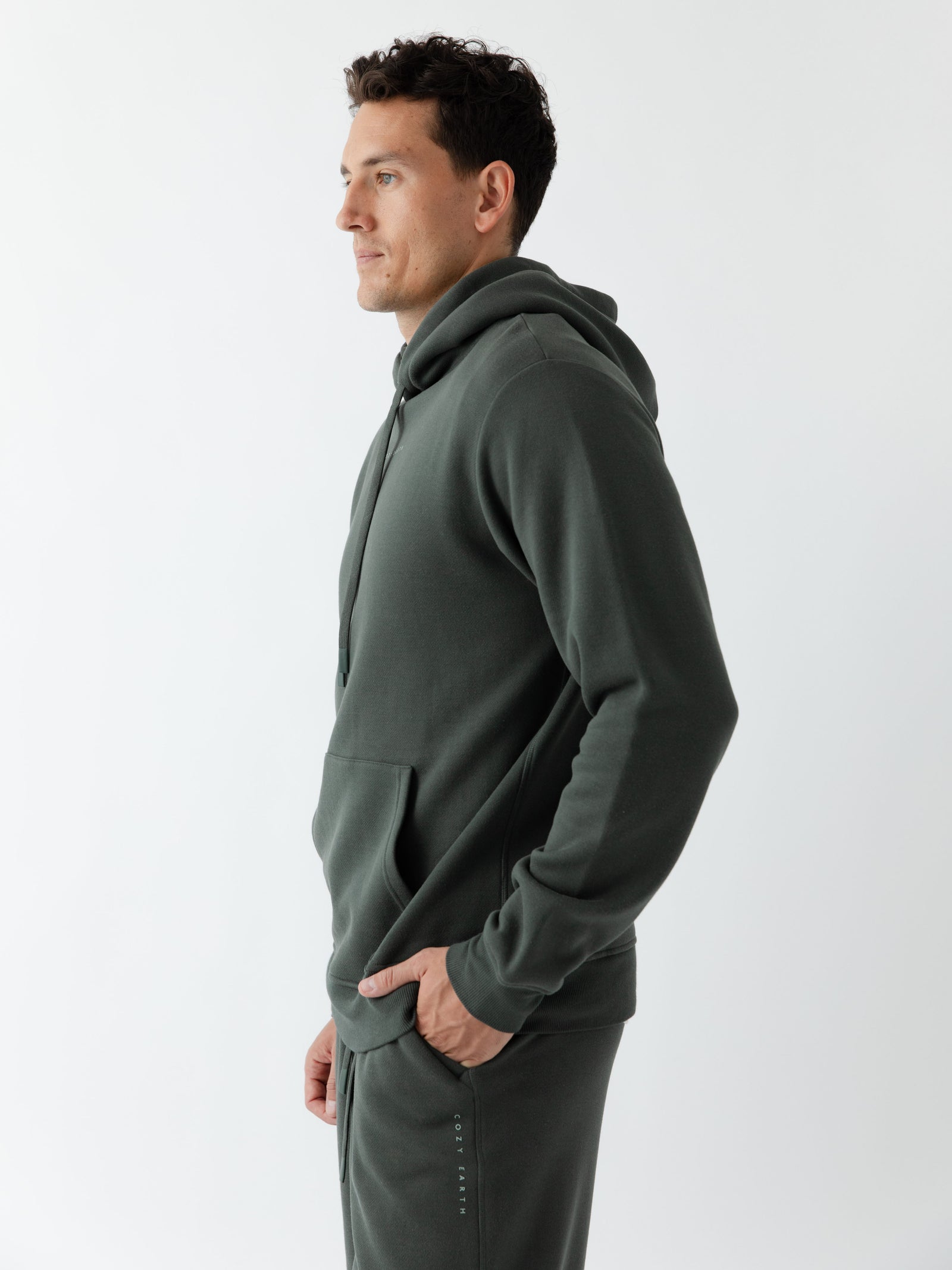 Side view of man wearing storm cityscape hoodie with white background