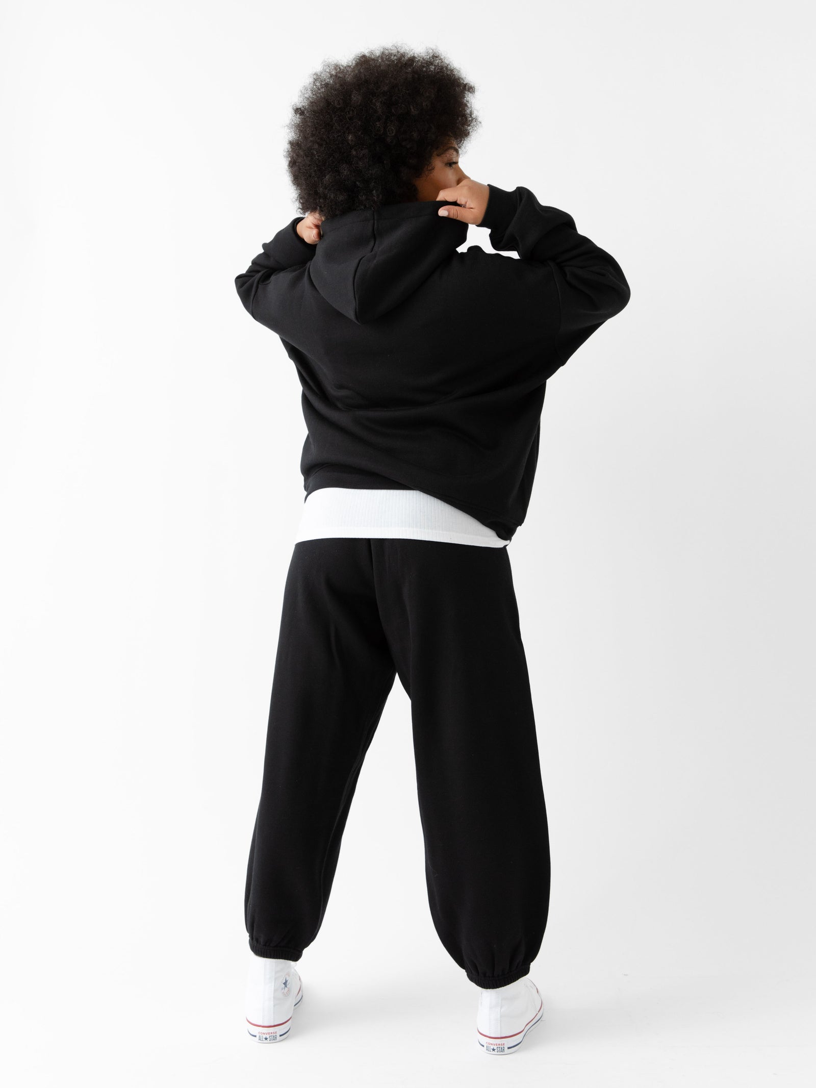 Back of woman wearing black cityscape hoodie set with white background