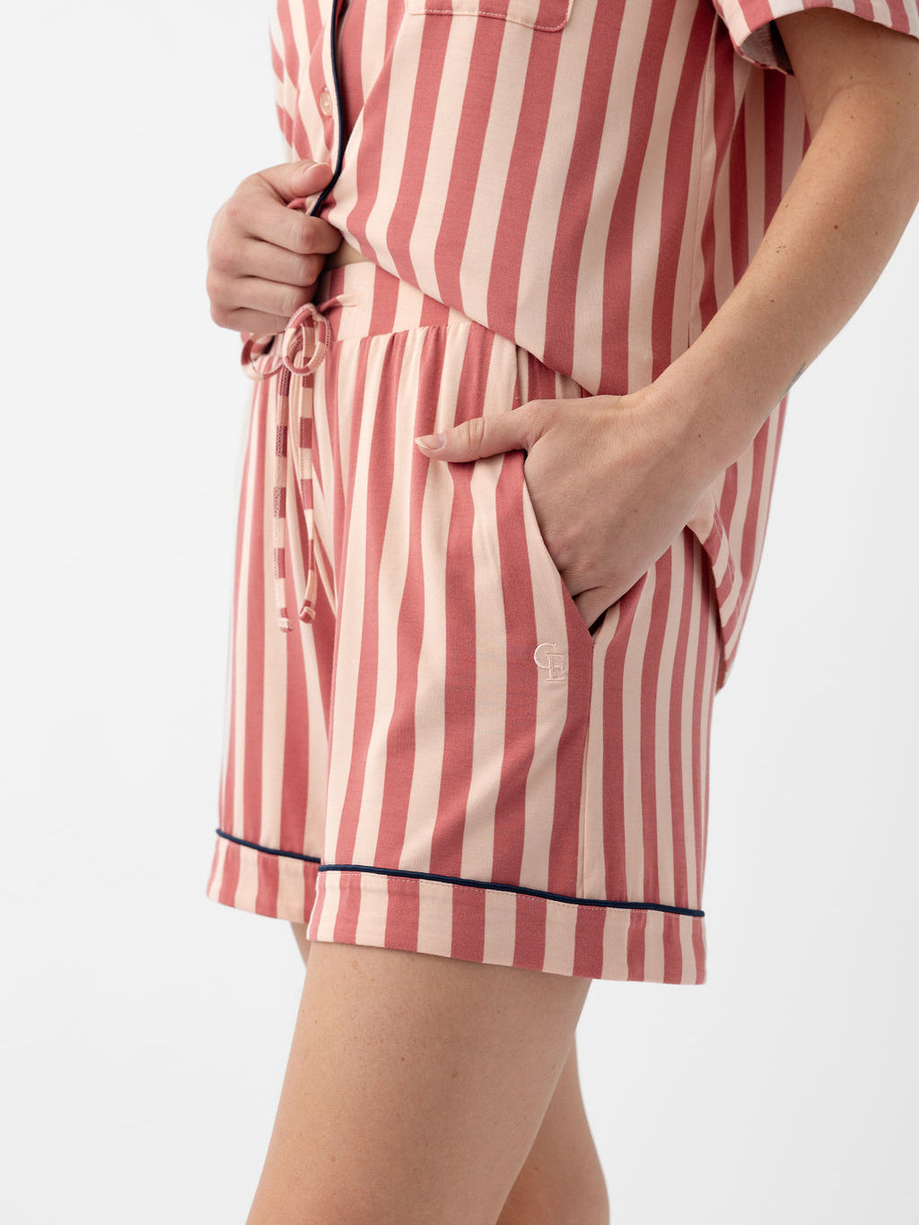 Woman wearing blush stripe pajama shorts 