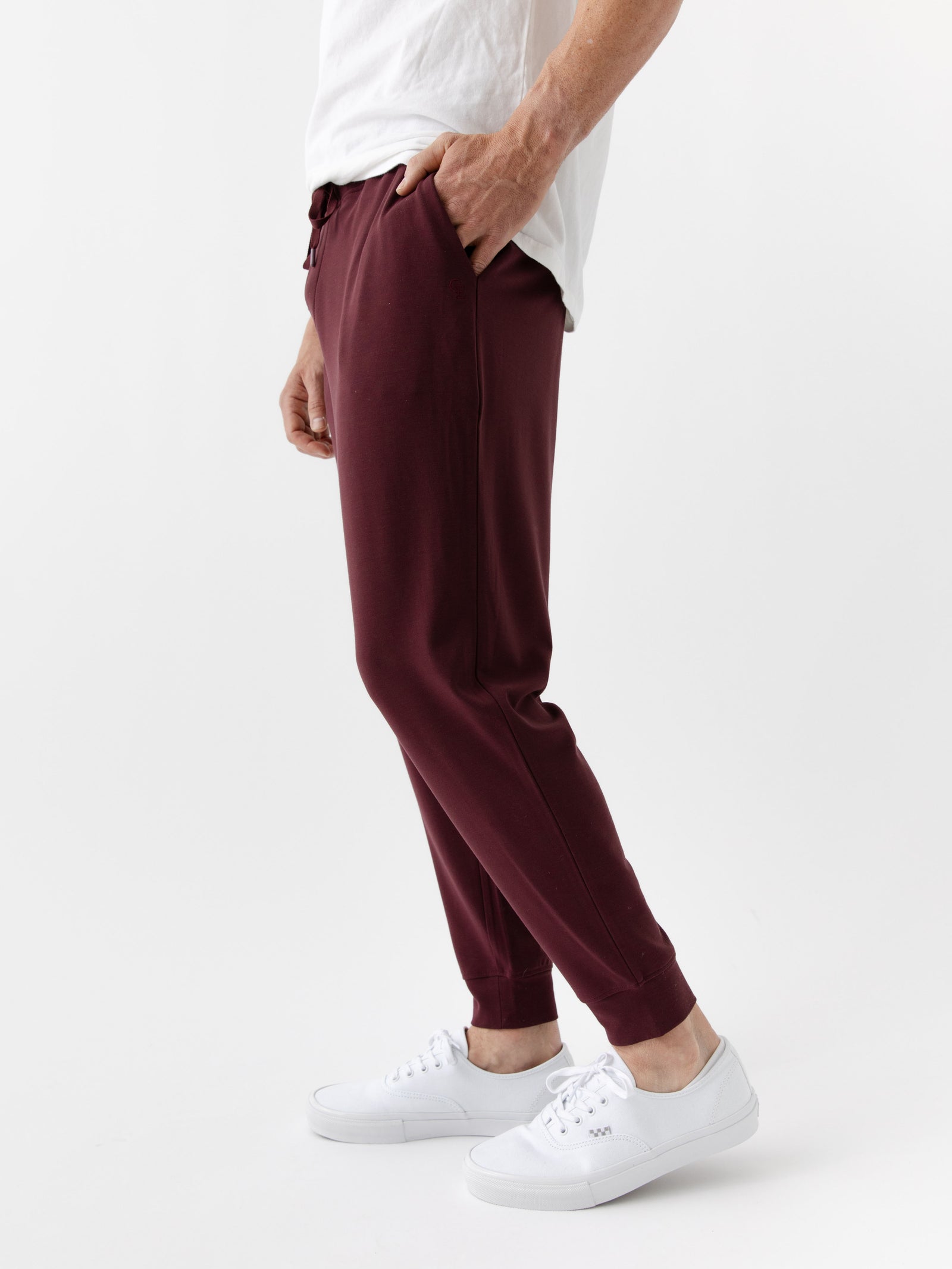Burgundy/Light GreyMen's Bamboo Jogger Set. There is a man wearing the jogger set. He is standing in a well lit room in a home.