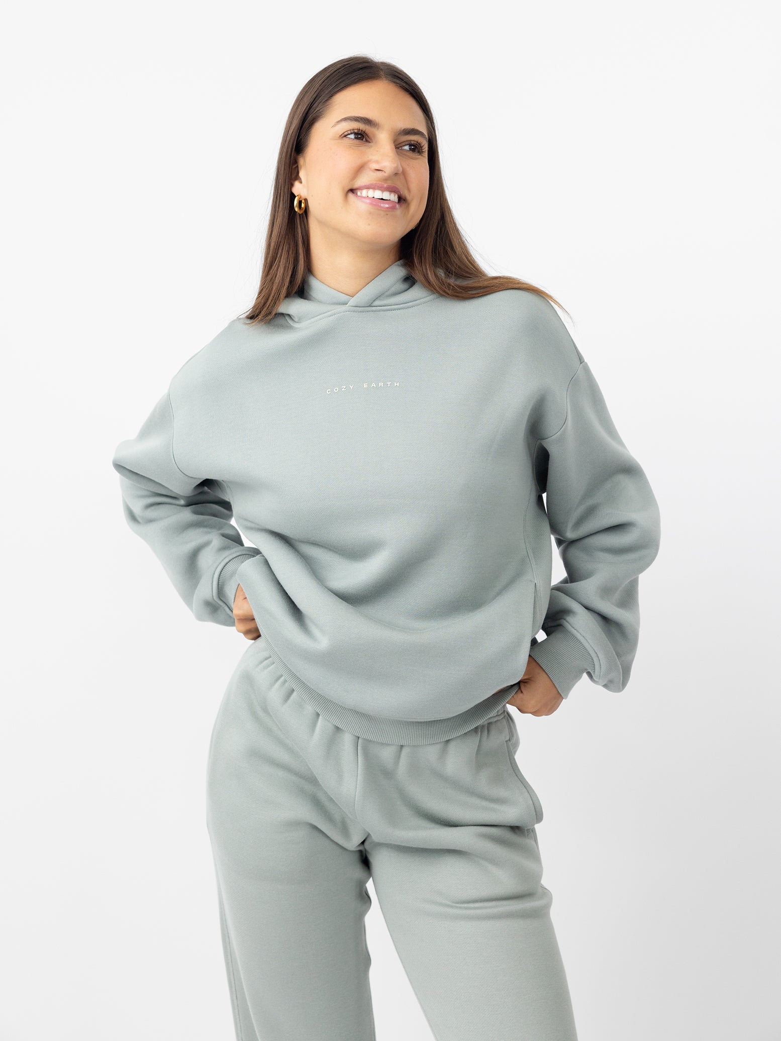 Woman smiling wearing haze cityscape hoodie with white background 