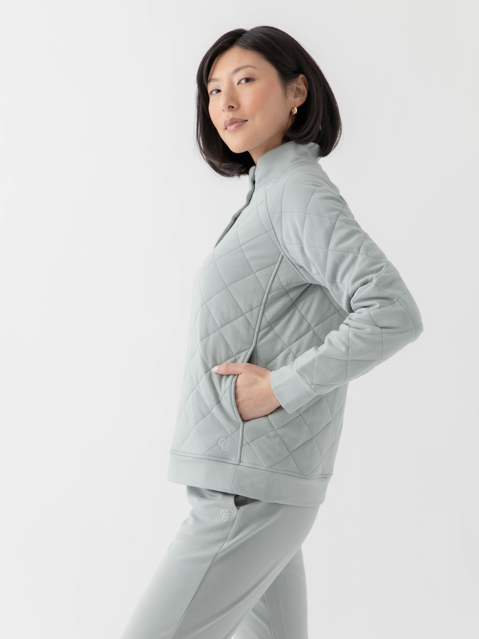 Woman wearing a white Cozy Earth Brushed Bamboo Quilted Pullover against a white background