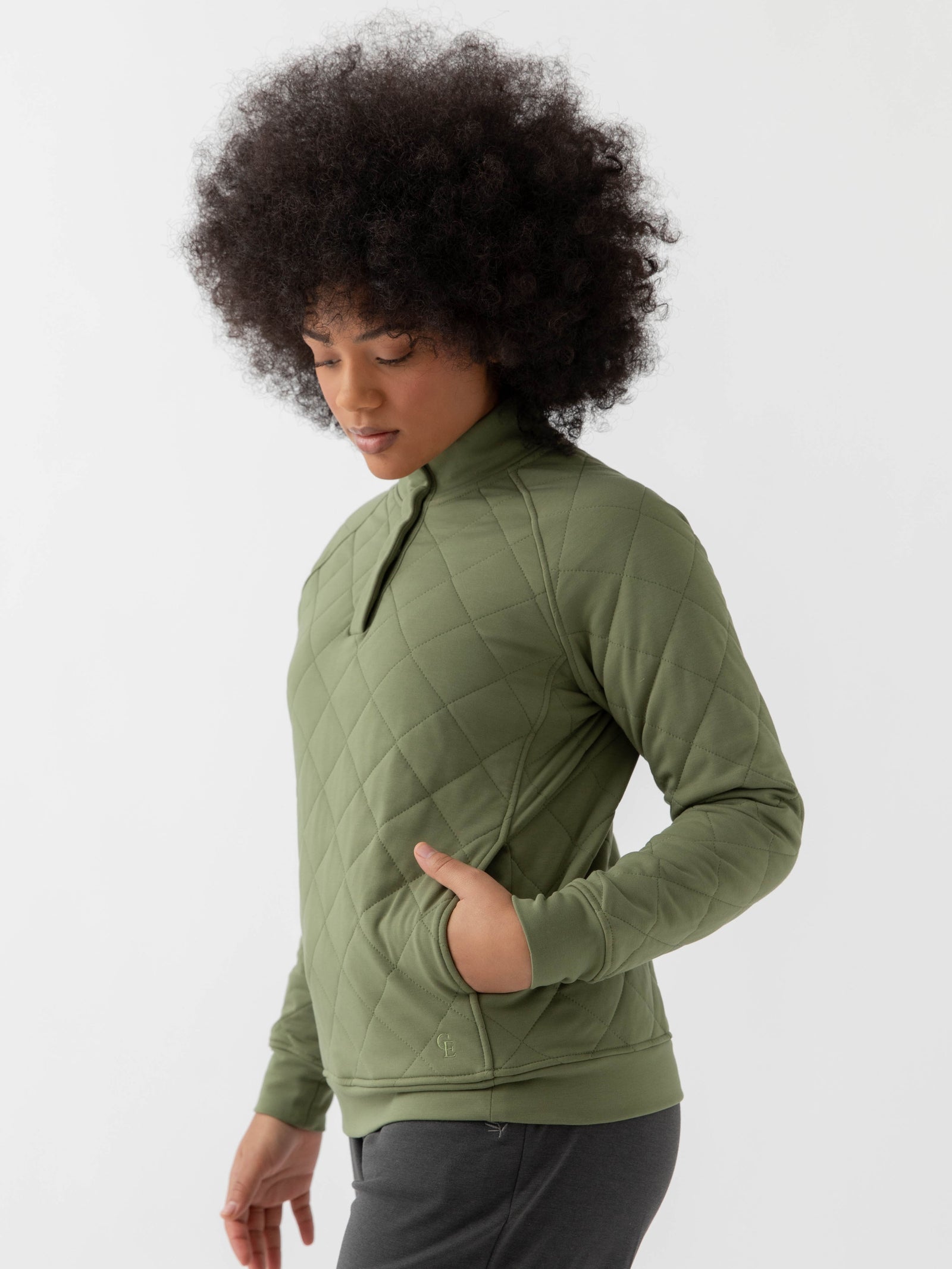 Woman wearing a green Cozy Earth Brushed Bamboo Quilted Pullover against a white background