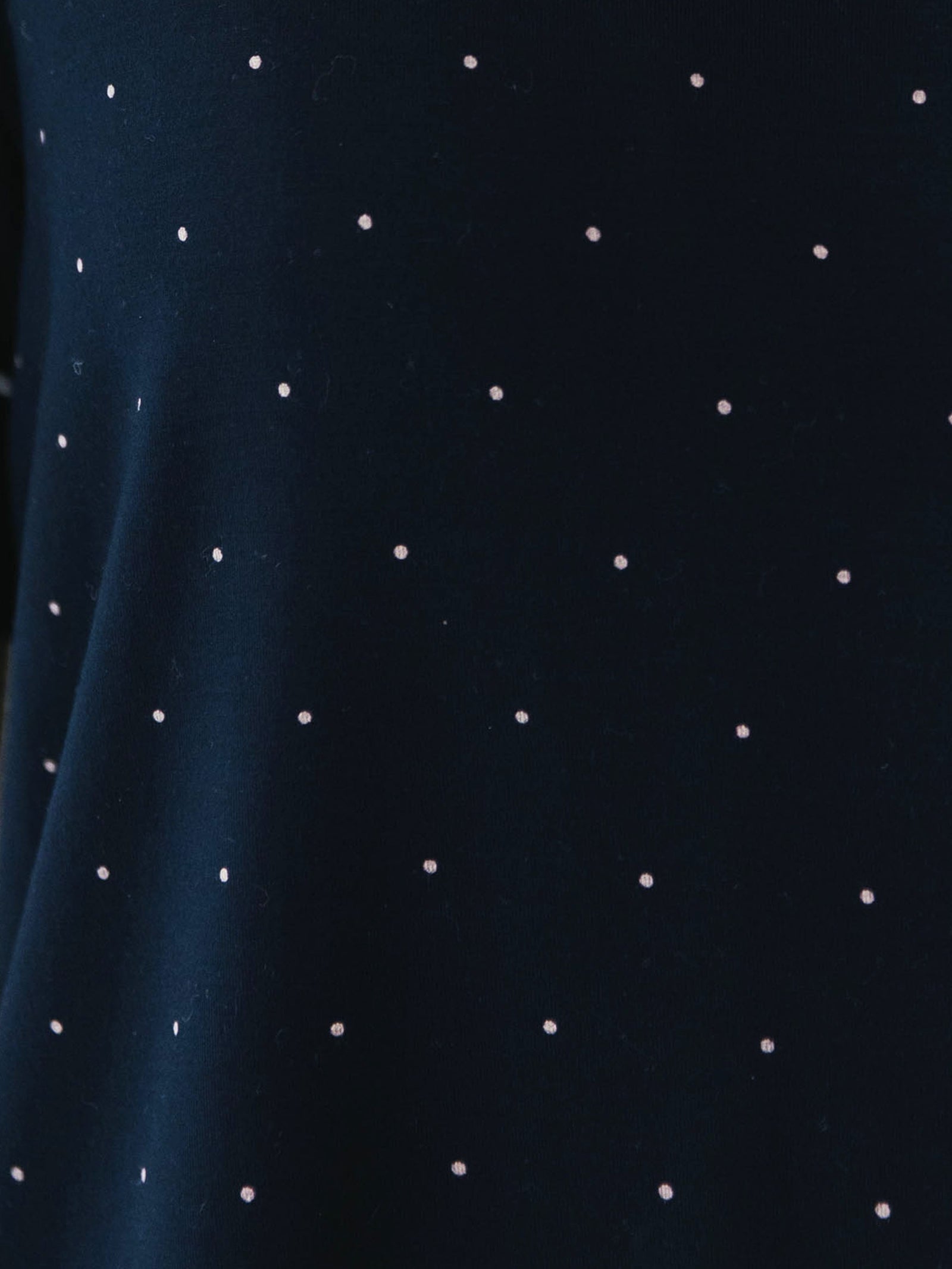 Mini Dot Sleeve & Pant Bamboo Pajama Set. The photo was taken close up, showing off the print of the pajamas.