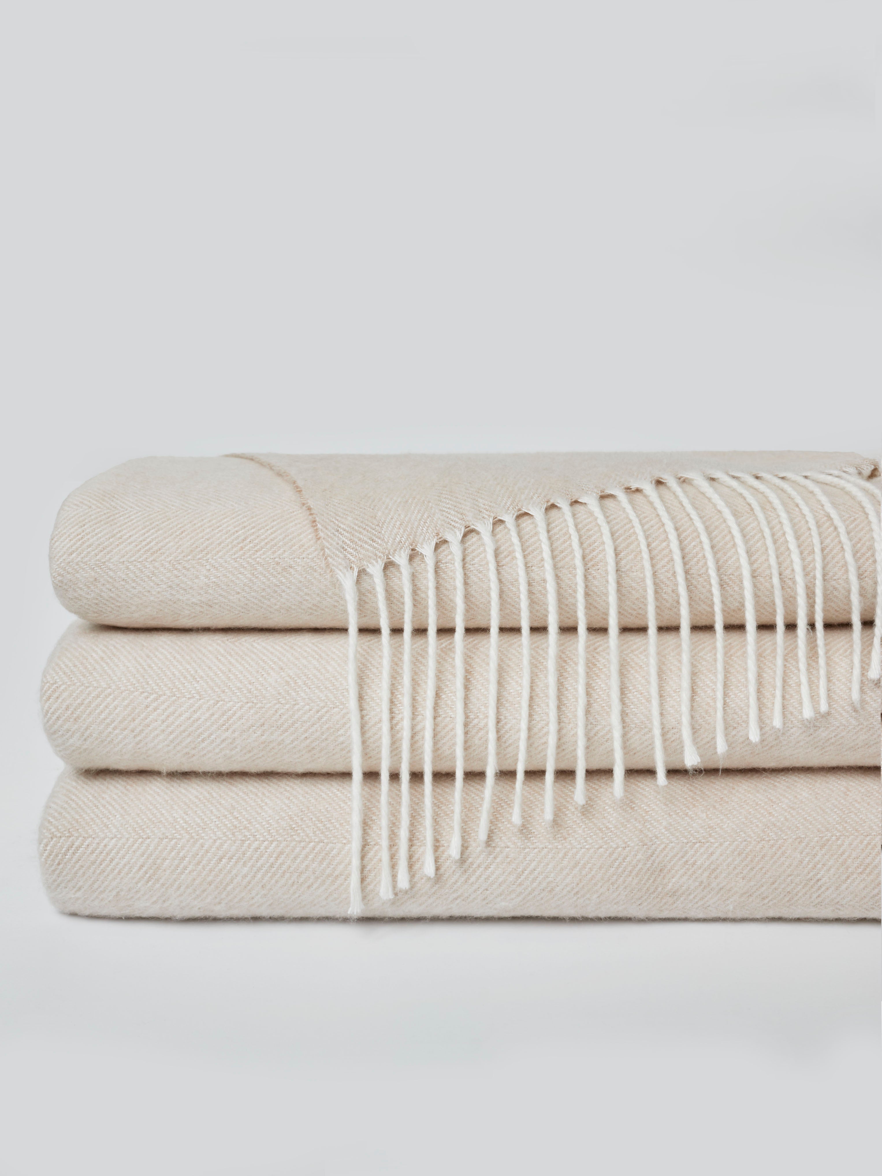 Oatmeal colored tassel throw folded with white background |Color:Oatmeal