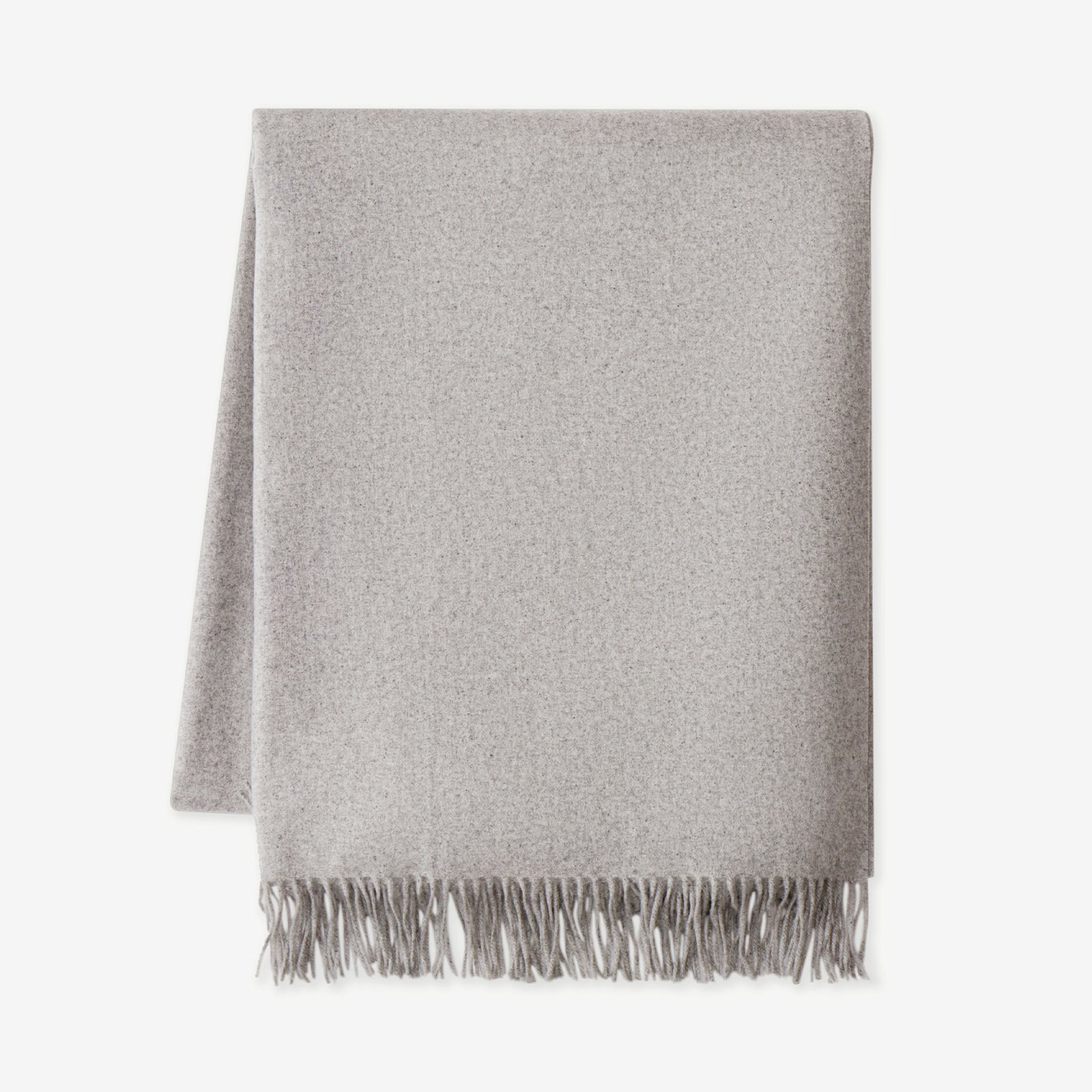 Pebble cashmere tassel throw flat lay with white background 