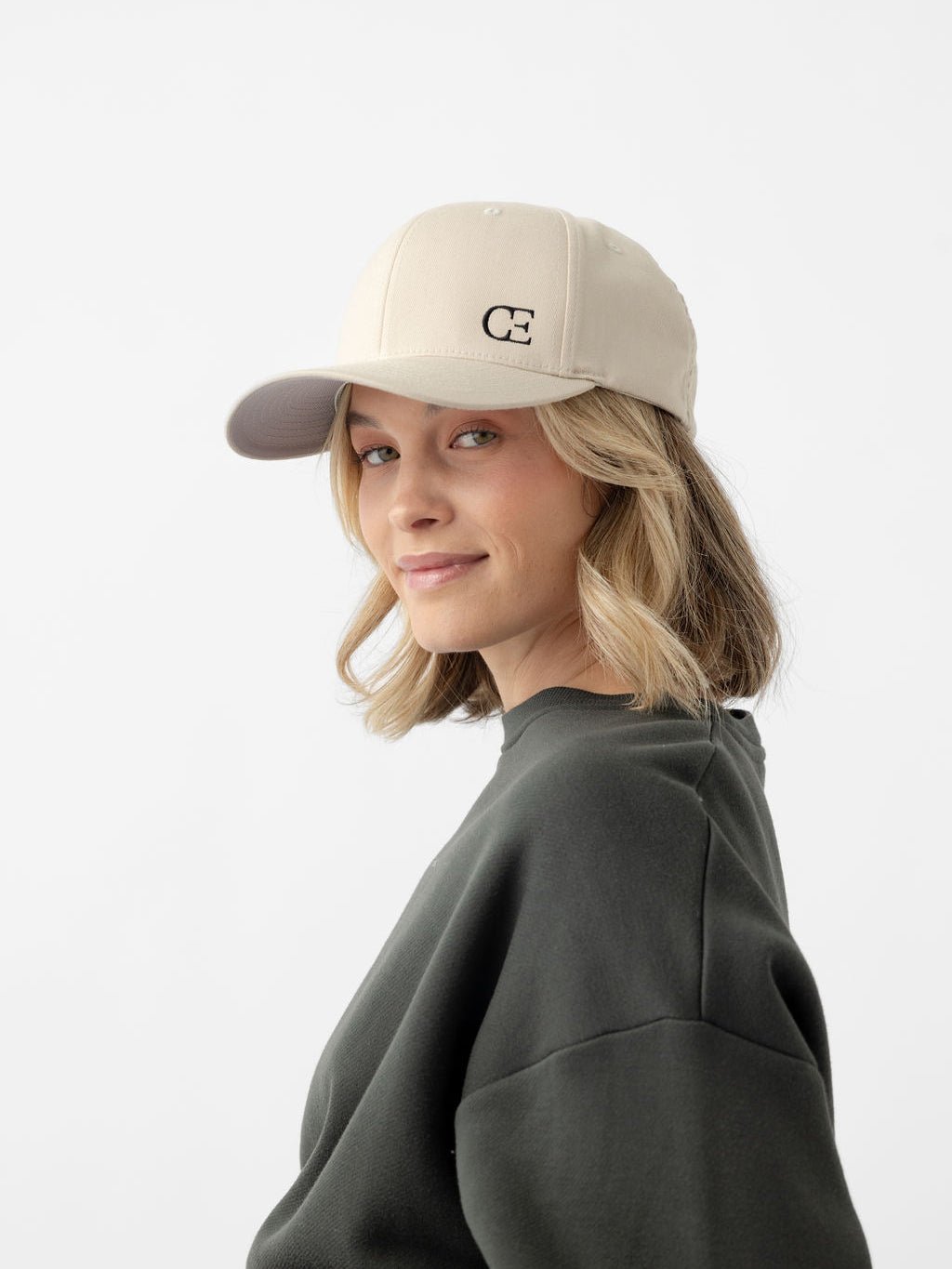 Woman with stone urban classic hat looking at camera 