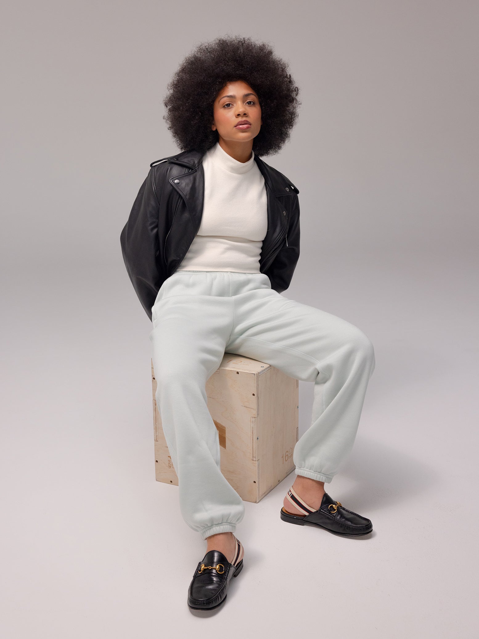 Arctic CityScape Joggers. The Joggers are being worn by a female model. The photo is taken with the models hand by the pocket of the joggers. The background is a grey hue.